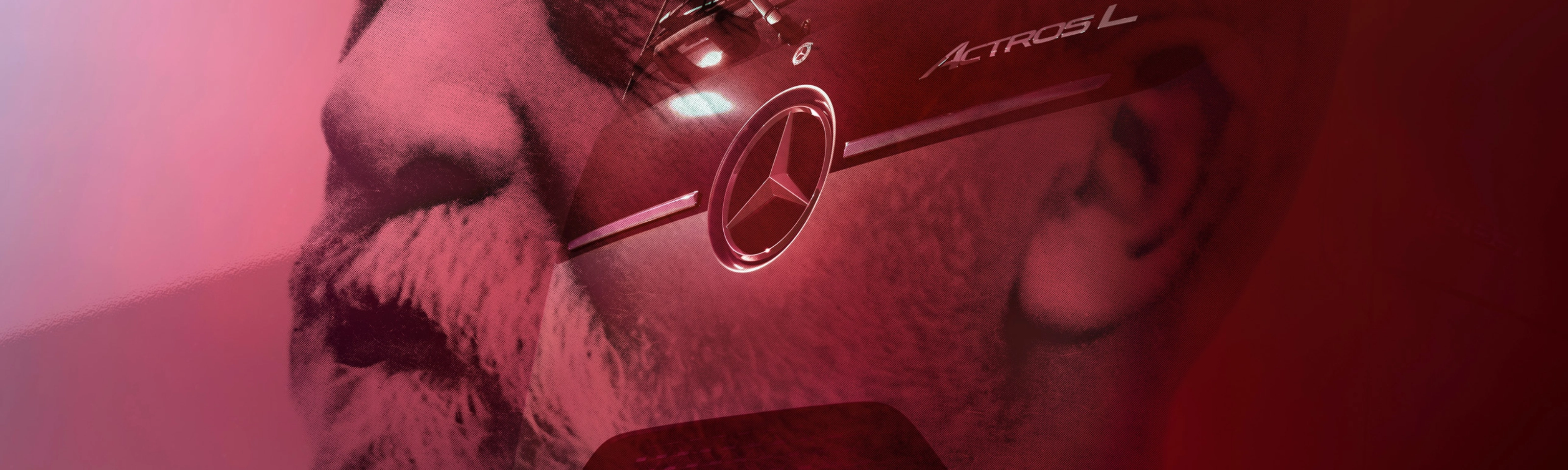 Mercedes-Benz Actros L truck displayed in front of a large portrait.