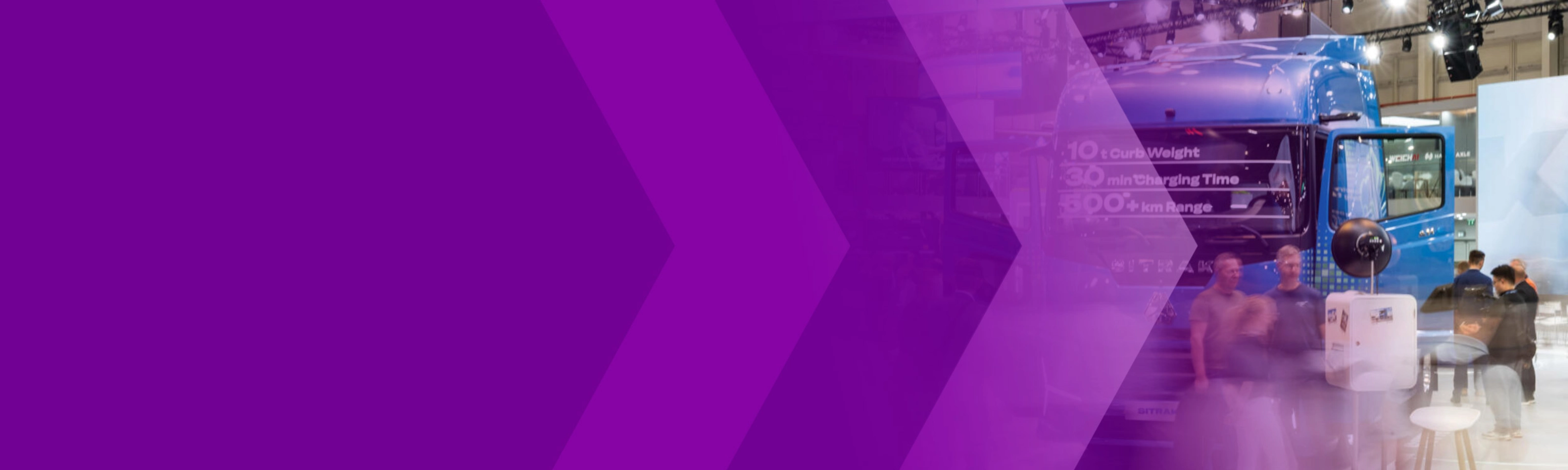 Trade show hall with a blue truck, visitors and a purple arrow graphic.