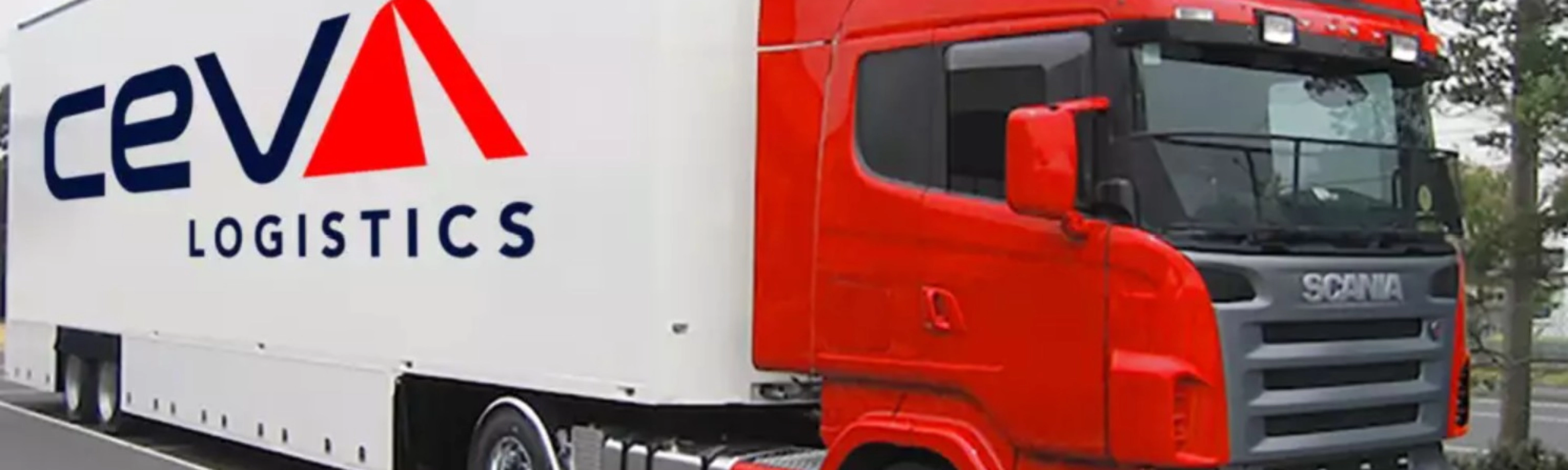 A red CEVA Logistics truck with trailer is parked on a street.
