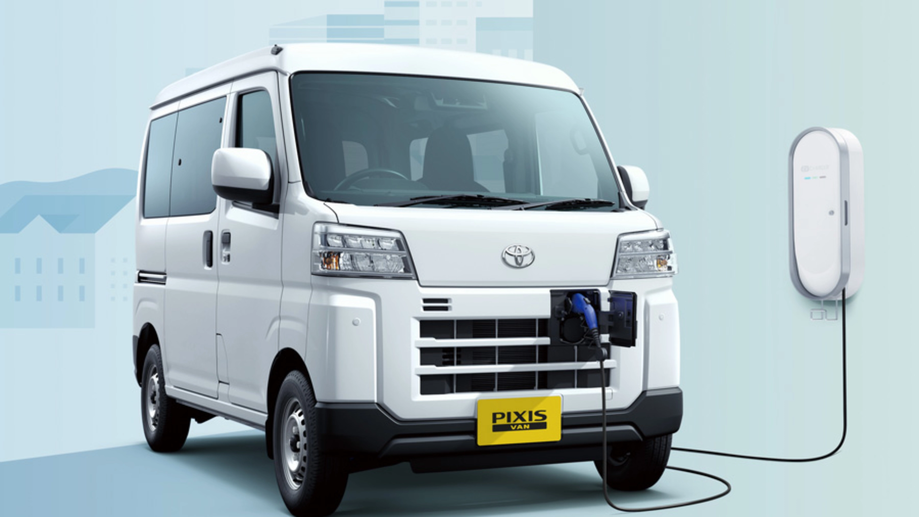 Electric van labeled "Pixis Van" is charging at a wall-mounted station via front charging port.