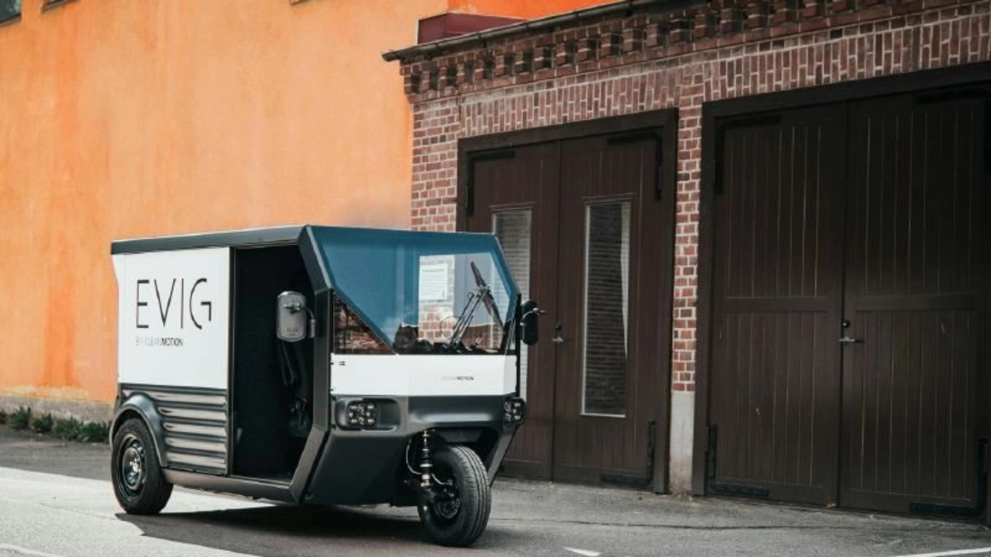 CleanMotion EVIG electric cargo vehicle parked beside a building.