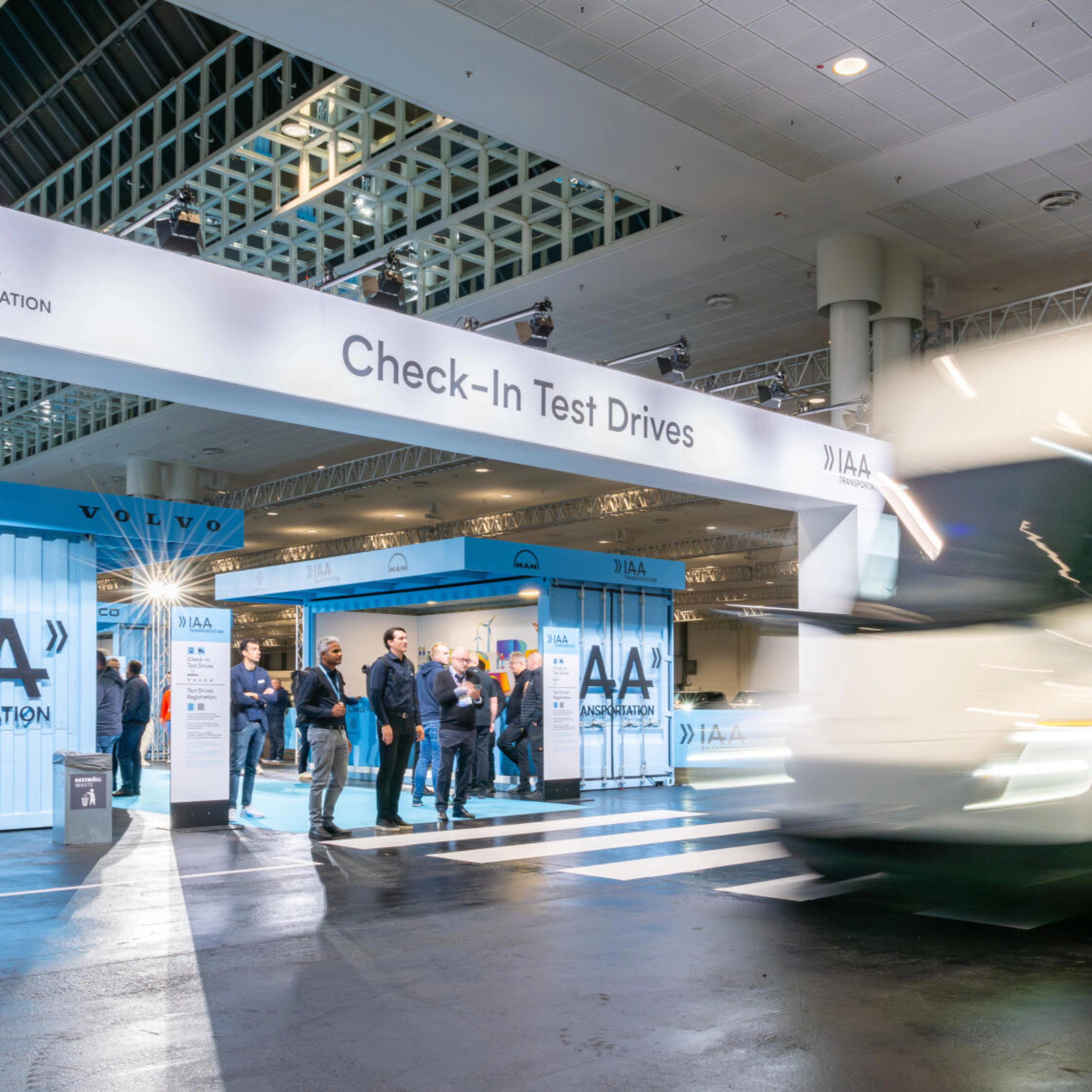 IAA Transportation Check-In area for test drives with truck passing by.