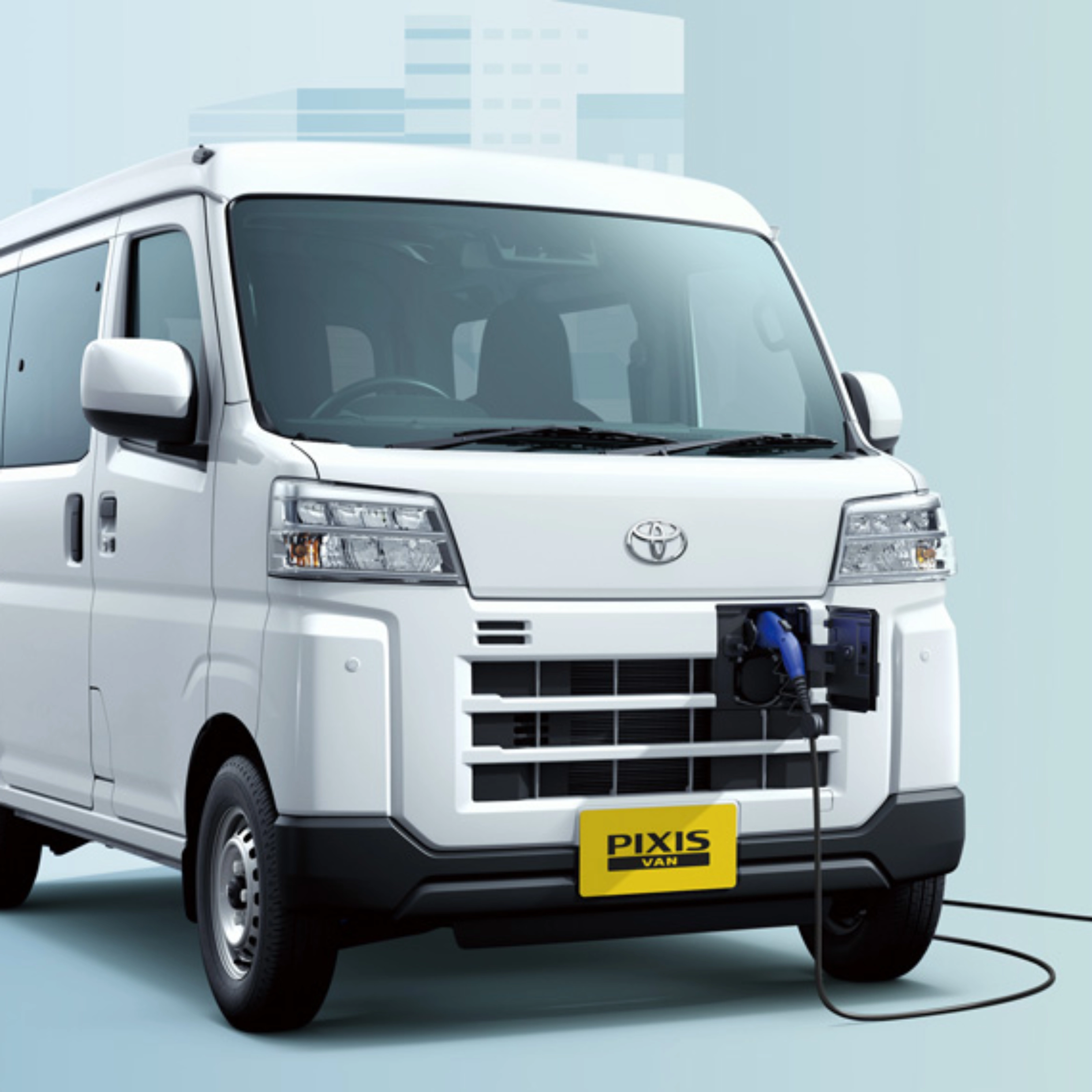 Electric van labeled "Pixis Van" is charging at a wall-mounted station via front charging port.
