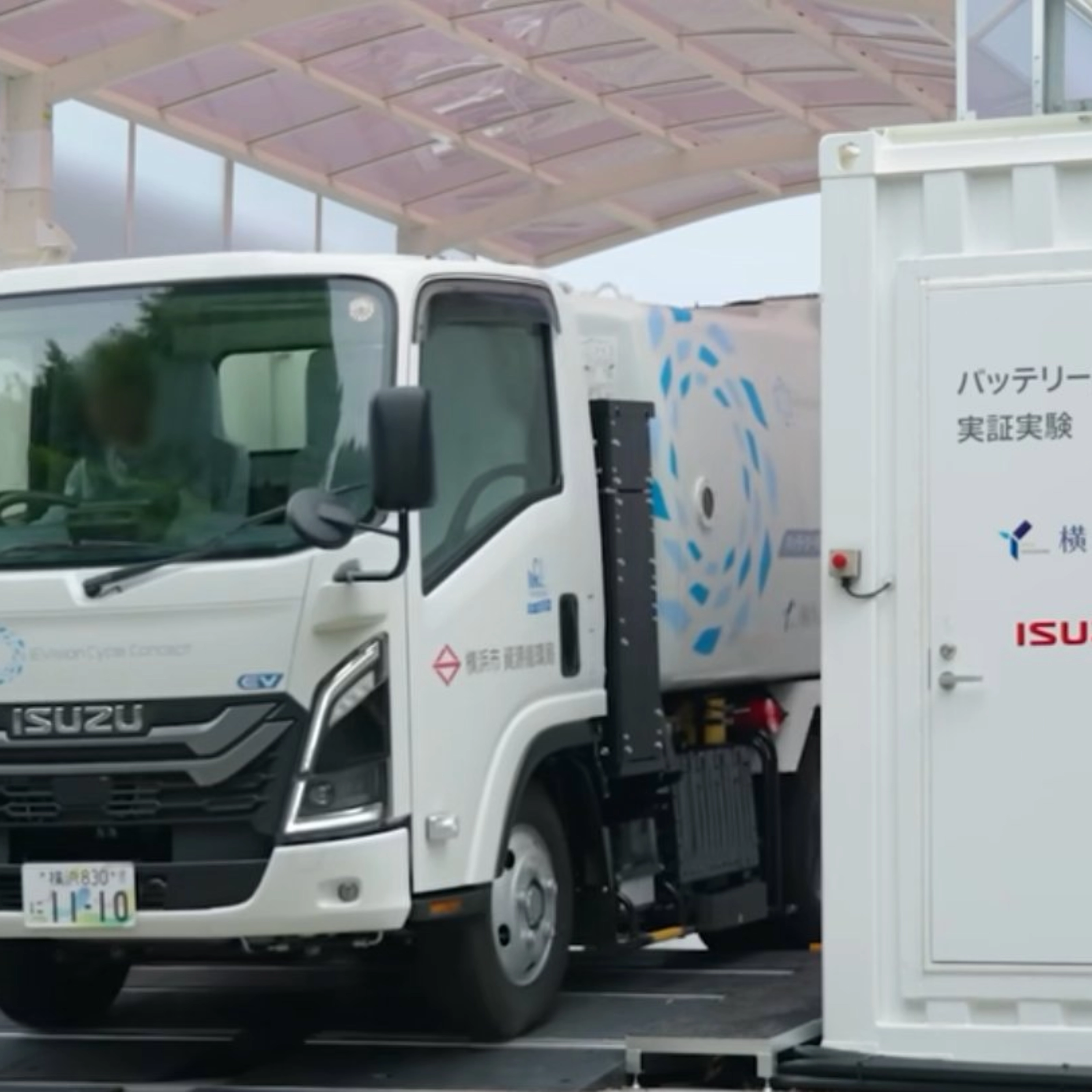 Isuzu truck displayed at an exhibition beside an information board.