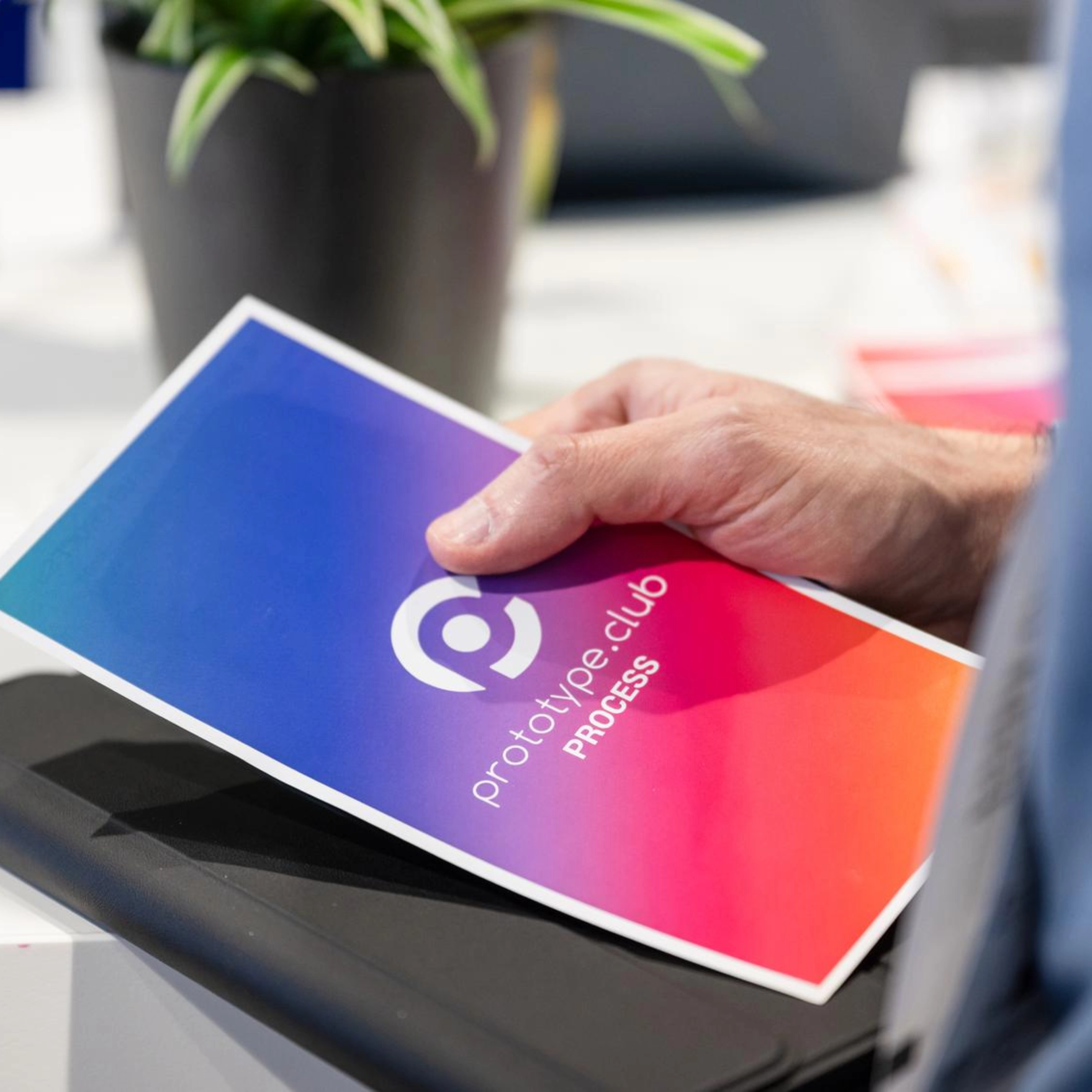 Person holding a prototype.club Process brochure at IAA Transportation.