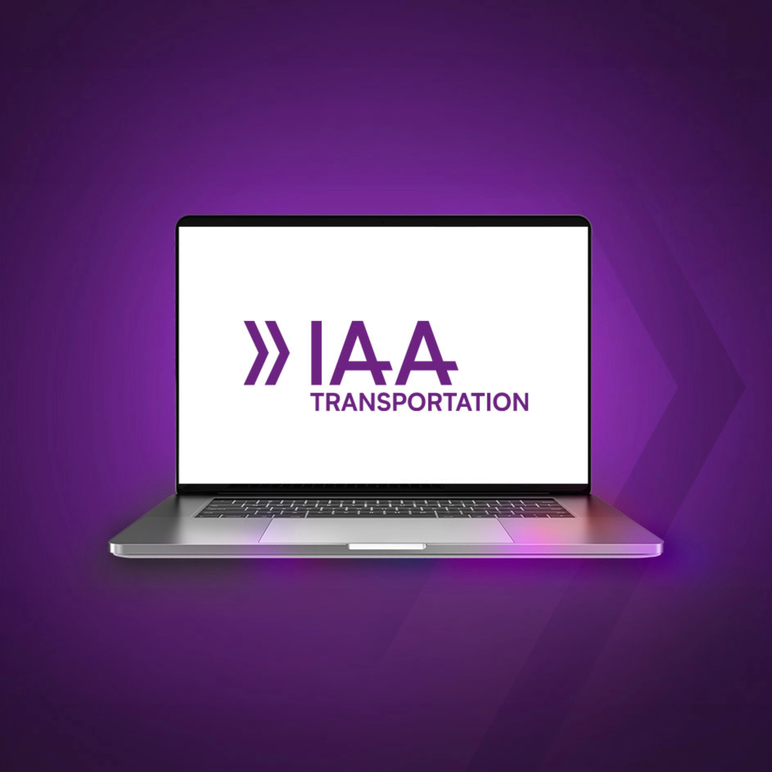 Laptop screen showing the IAA Transportation logo on a purple background.