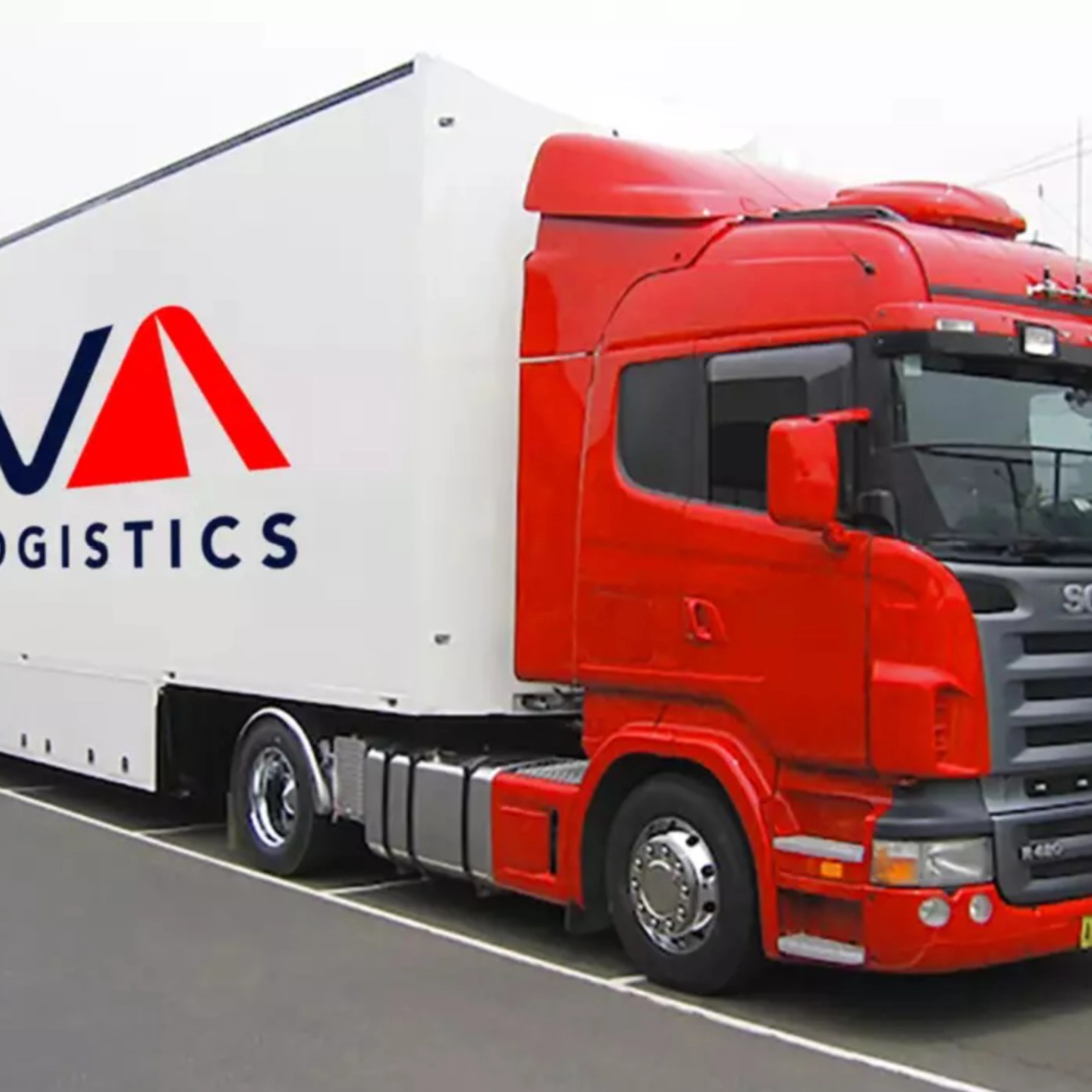 A red CEVA Logistics truck with trailer is parked on a street.