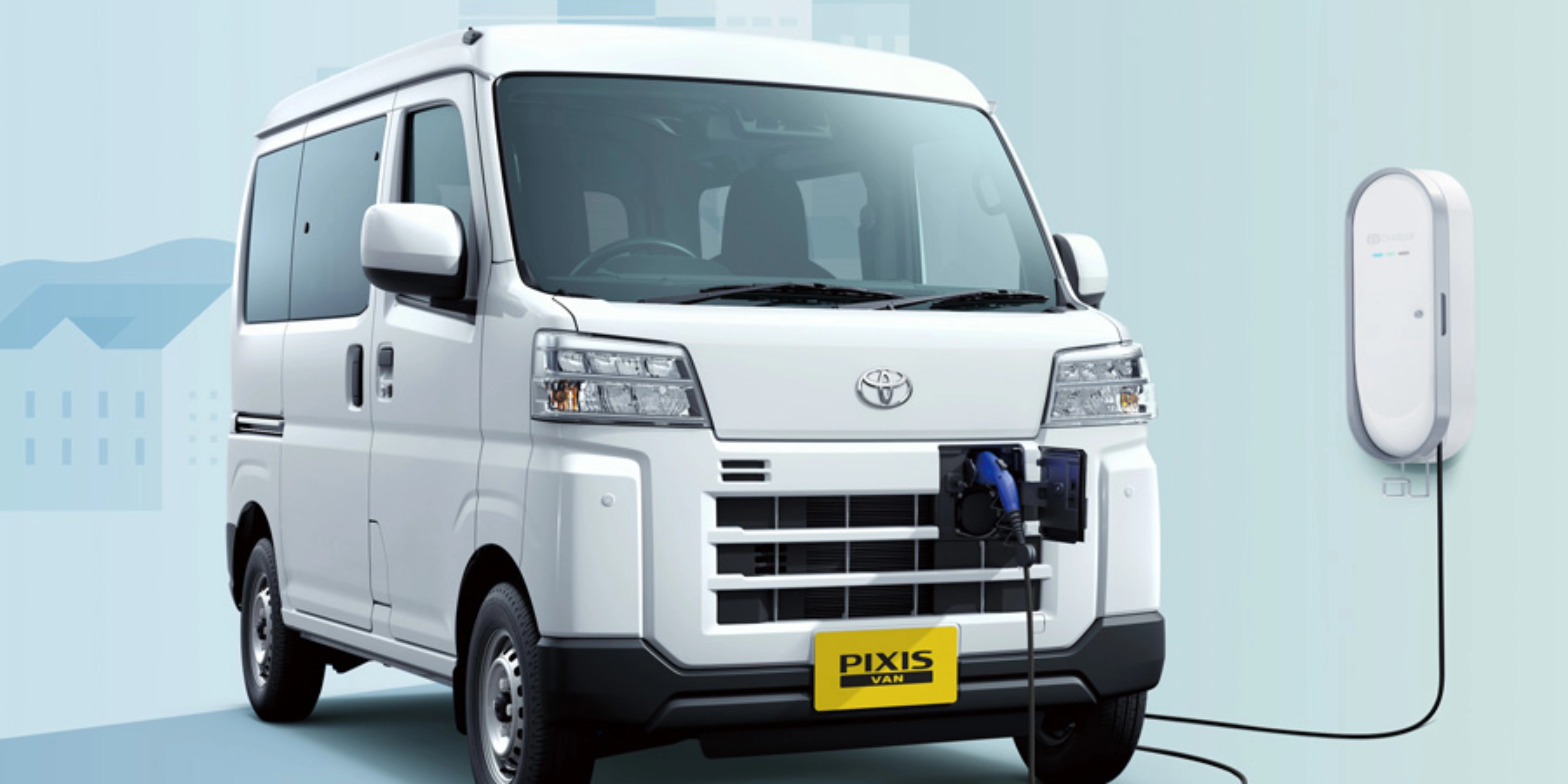 Electric van labeled "Pixis Van" is charging at a wall-mounted station via front charging port.