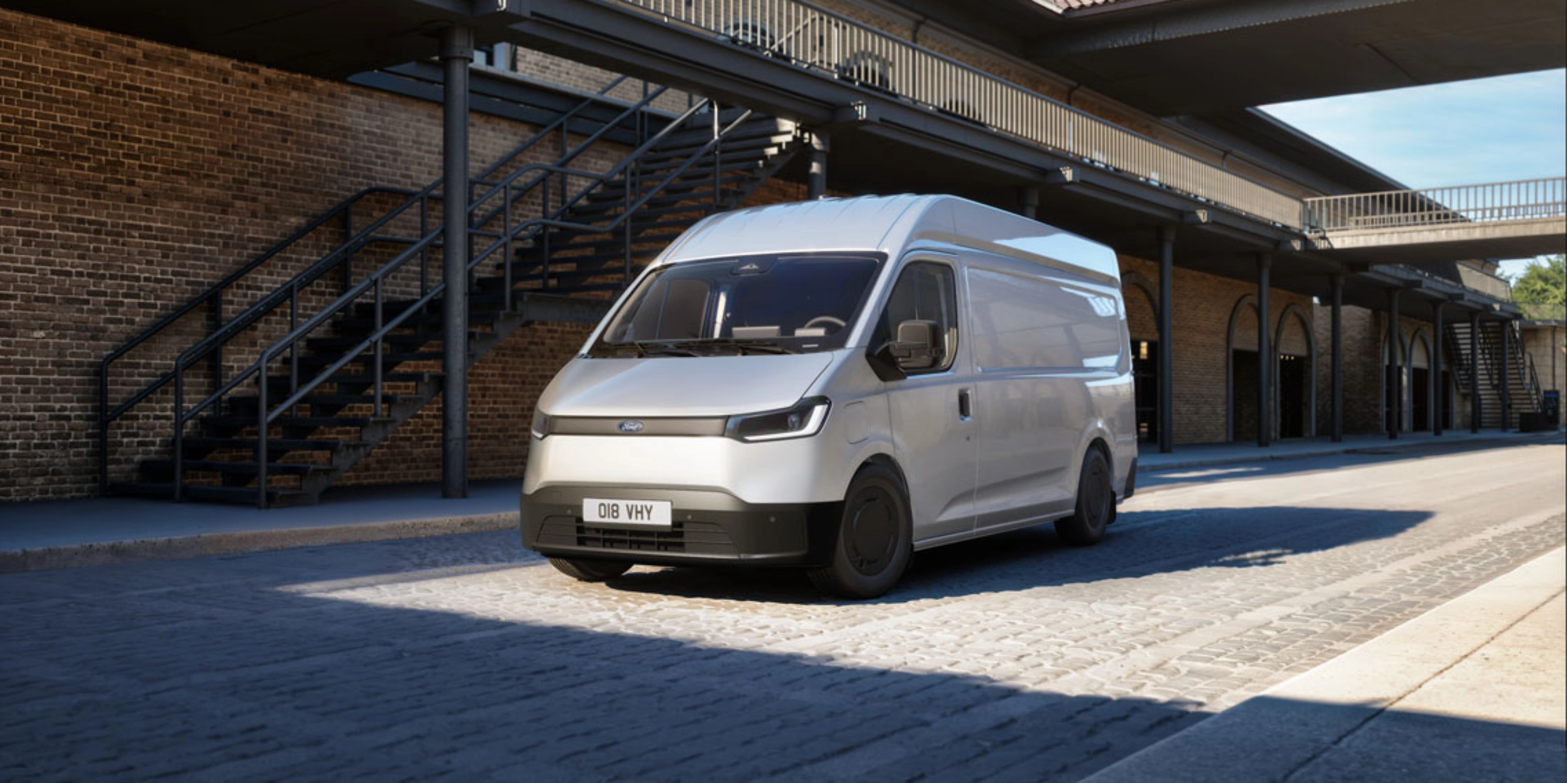 White van parked in a courtyard in front of a brick building