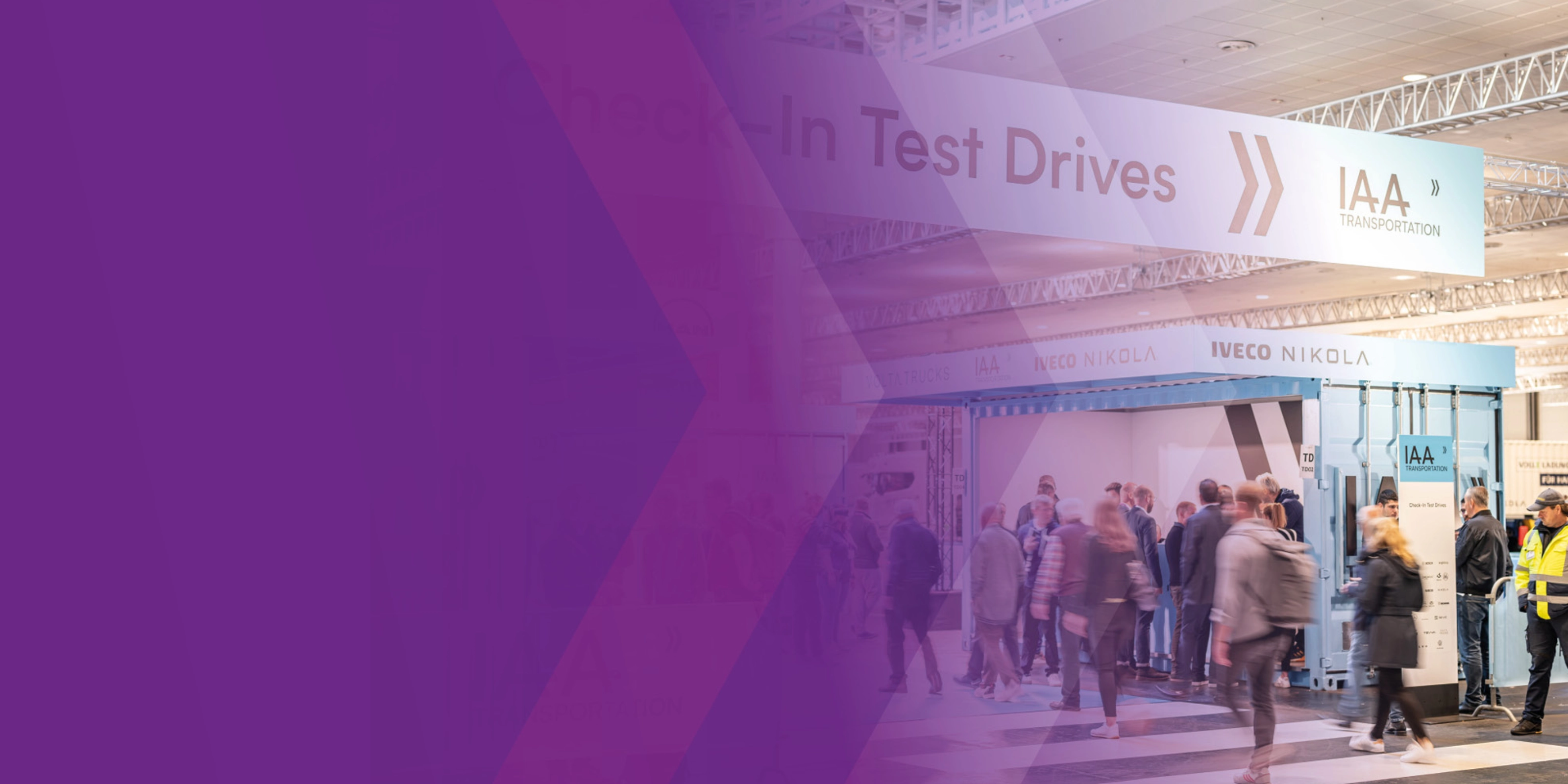 Visitors at IAA check-in area for test drives in exhibition hall.