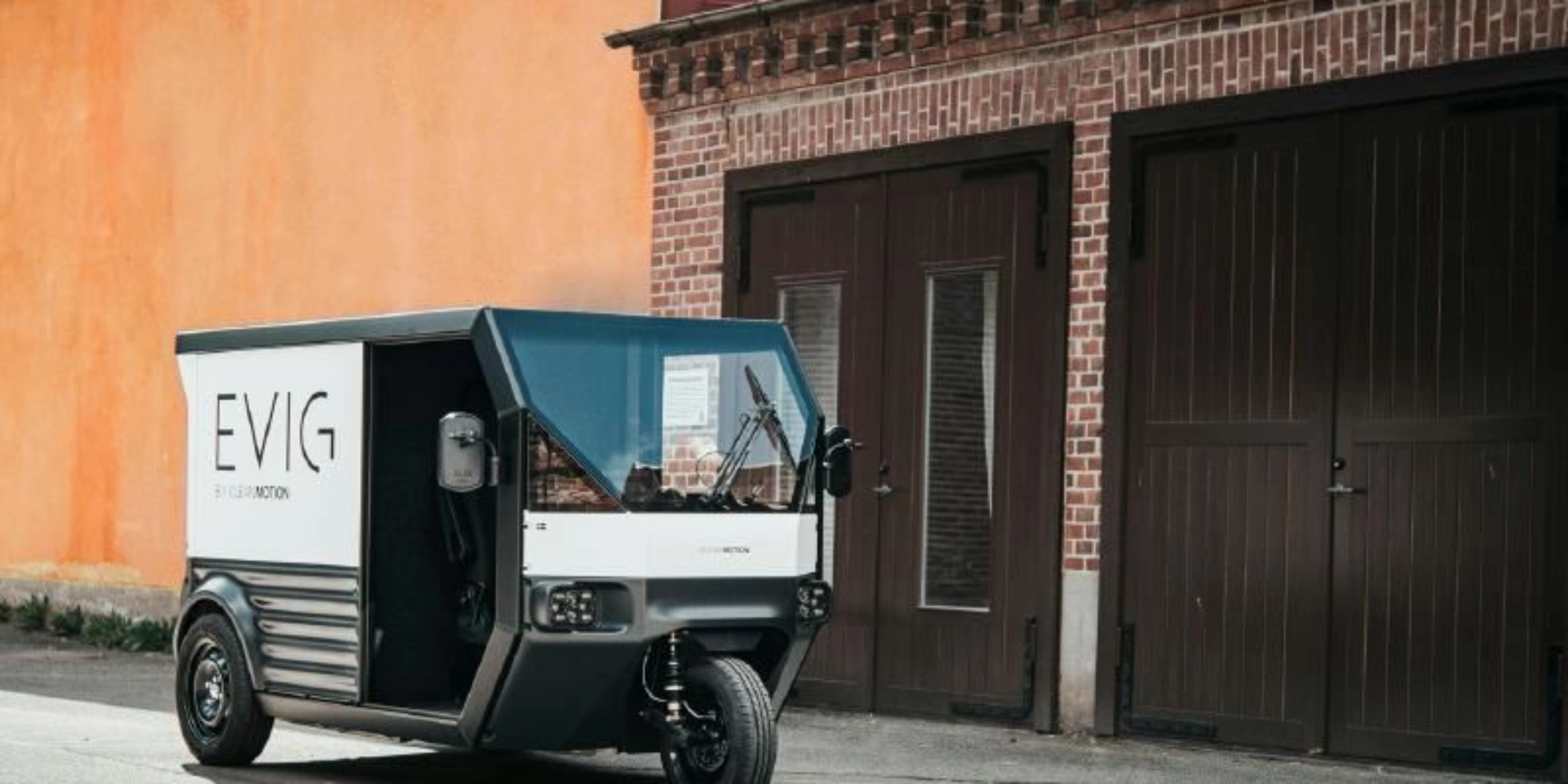 CleanMotion EVIG electric cargo vehicle parked beside a building.