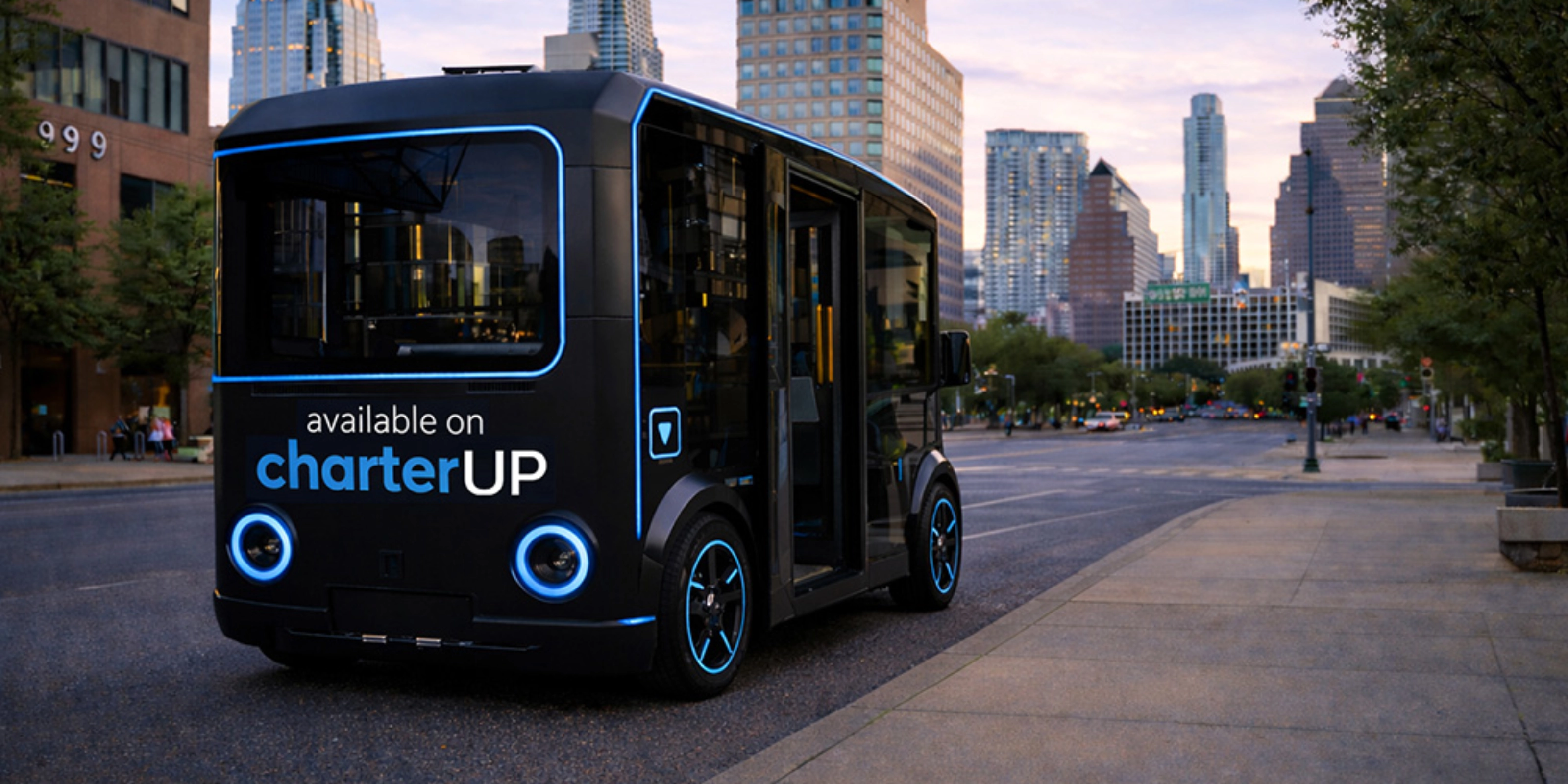 Small black electric shuttle bus with CharterUP logo in city street.