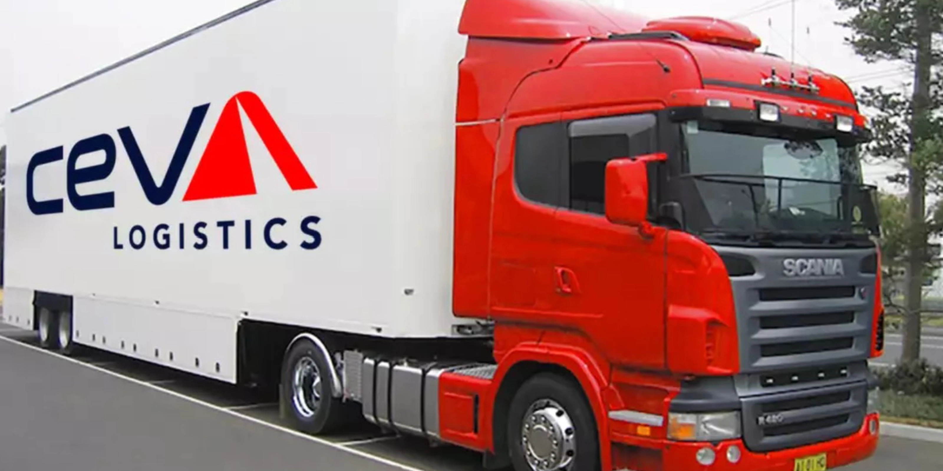 A red CEVA Logistics truck with trailer is parked on a street.