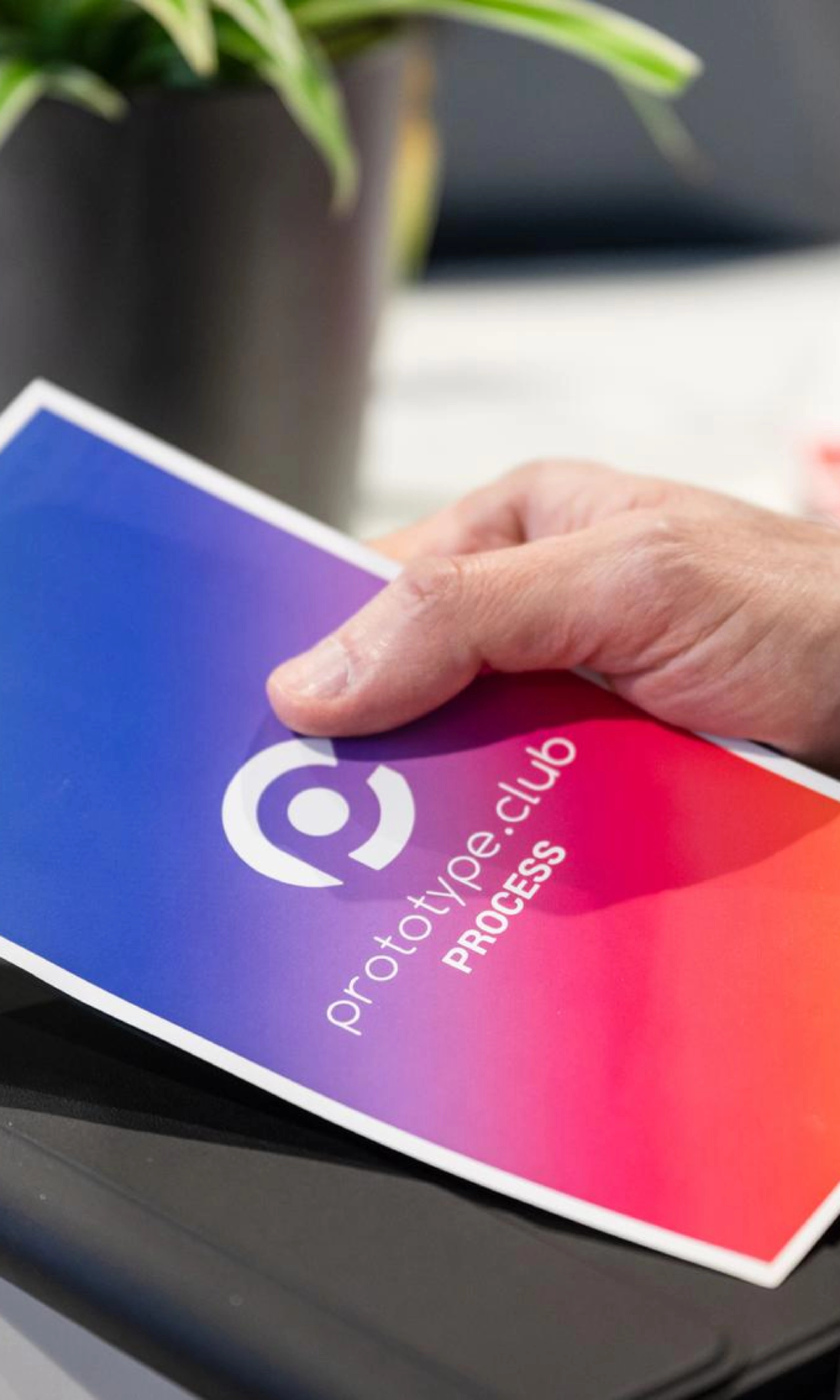Person holding a prototype.club Process brochure at IAA Transportation.
