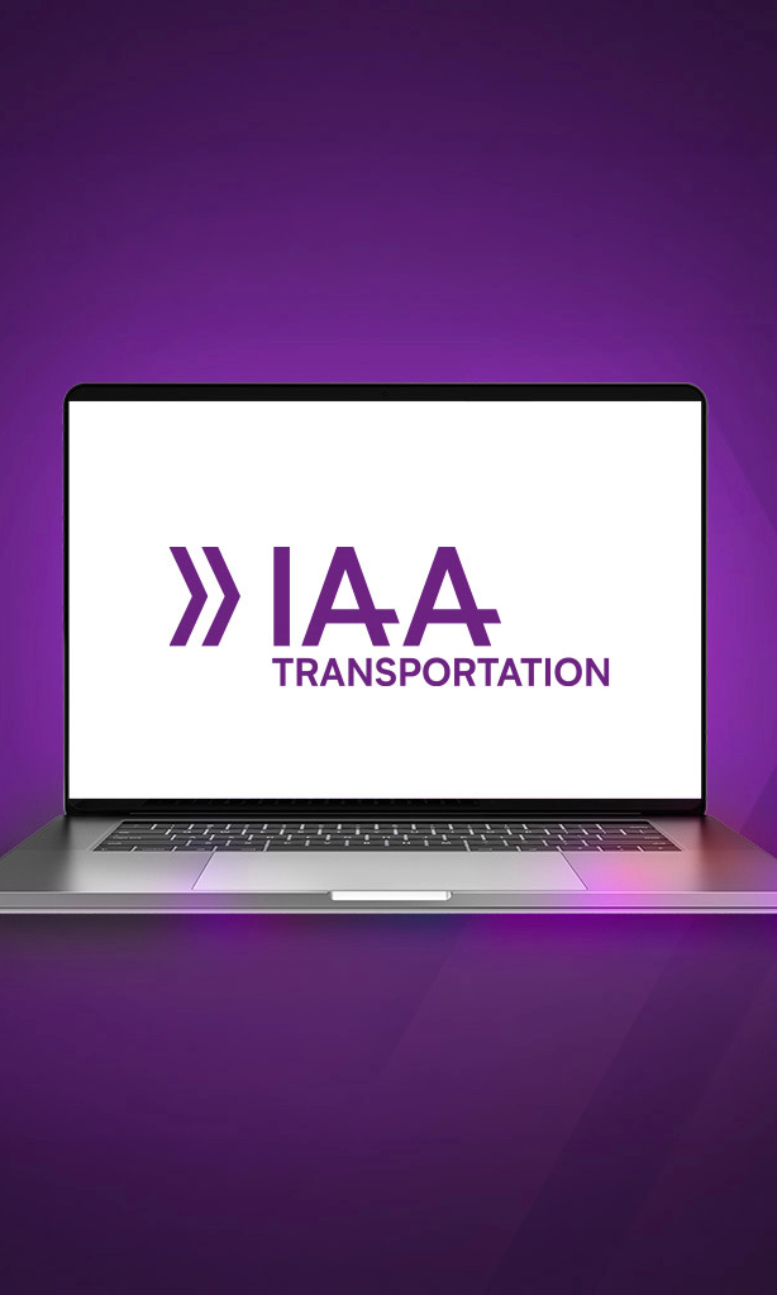 Laptop screen showing the IAA Transportation logo on a purple background.