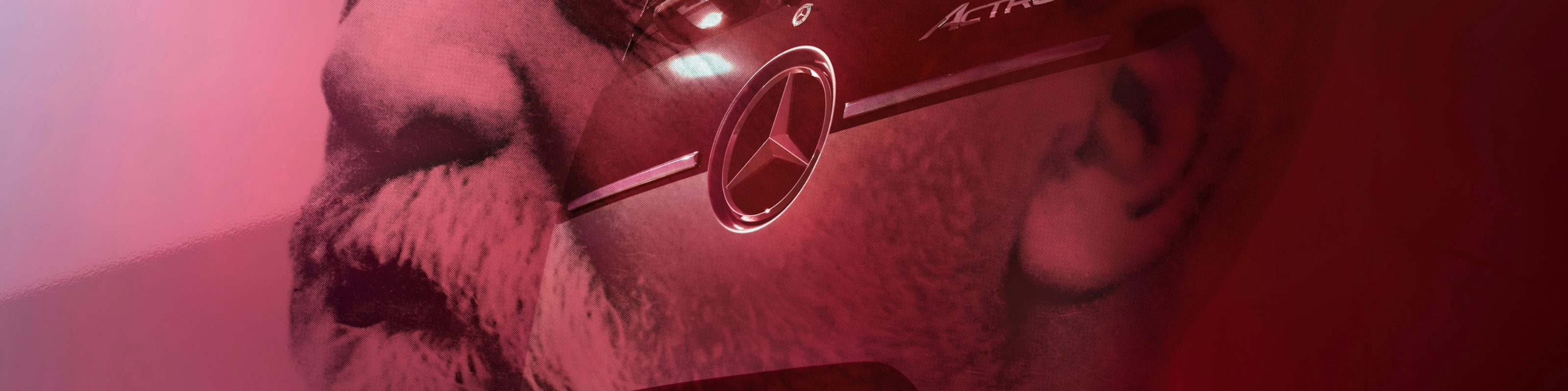 Mercedes-Benz Actros L truck displayed in front of a large portrait.