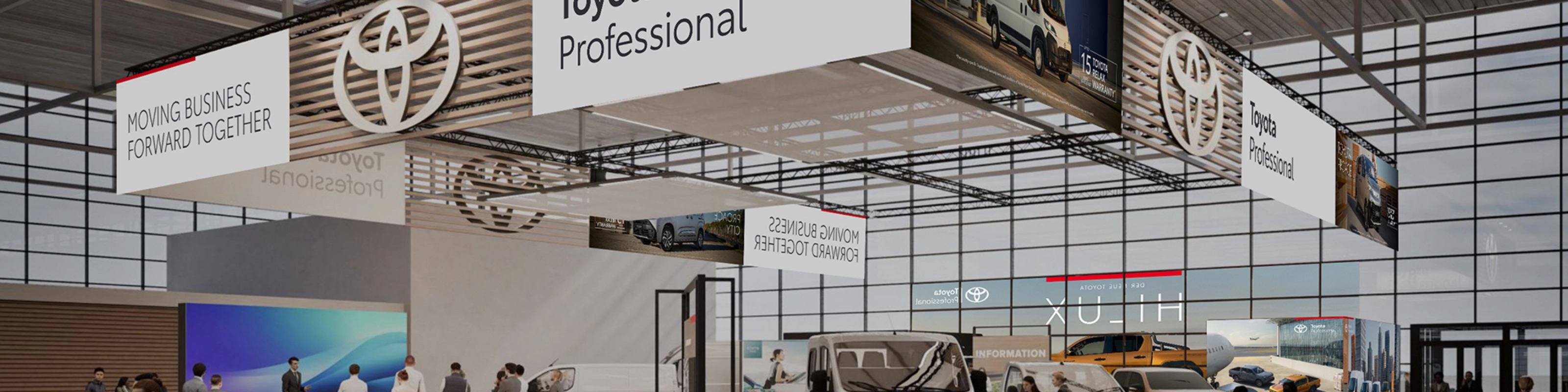 Toyota Professional exhibition stand with commercial vehicles and visitors at a trade fair.