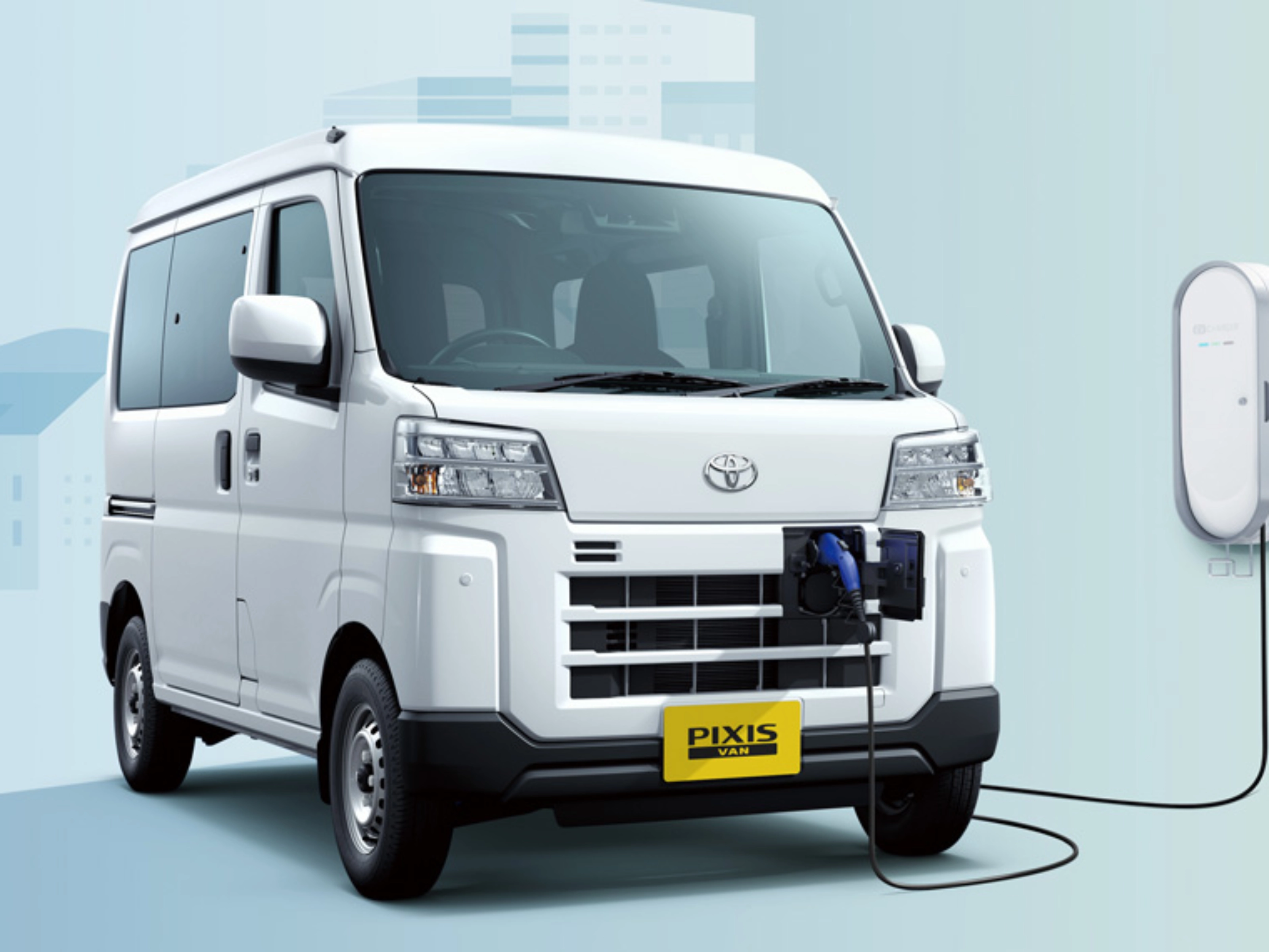 Electric van labeled "Pixis Van" is charging at a wall-mounted station via front charging port.