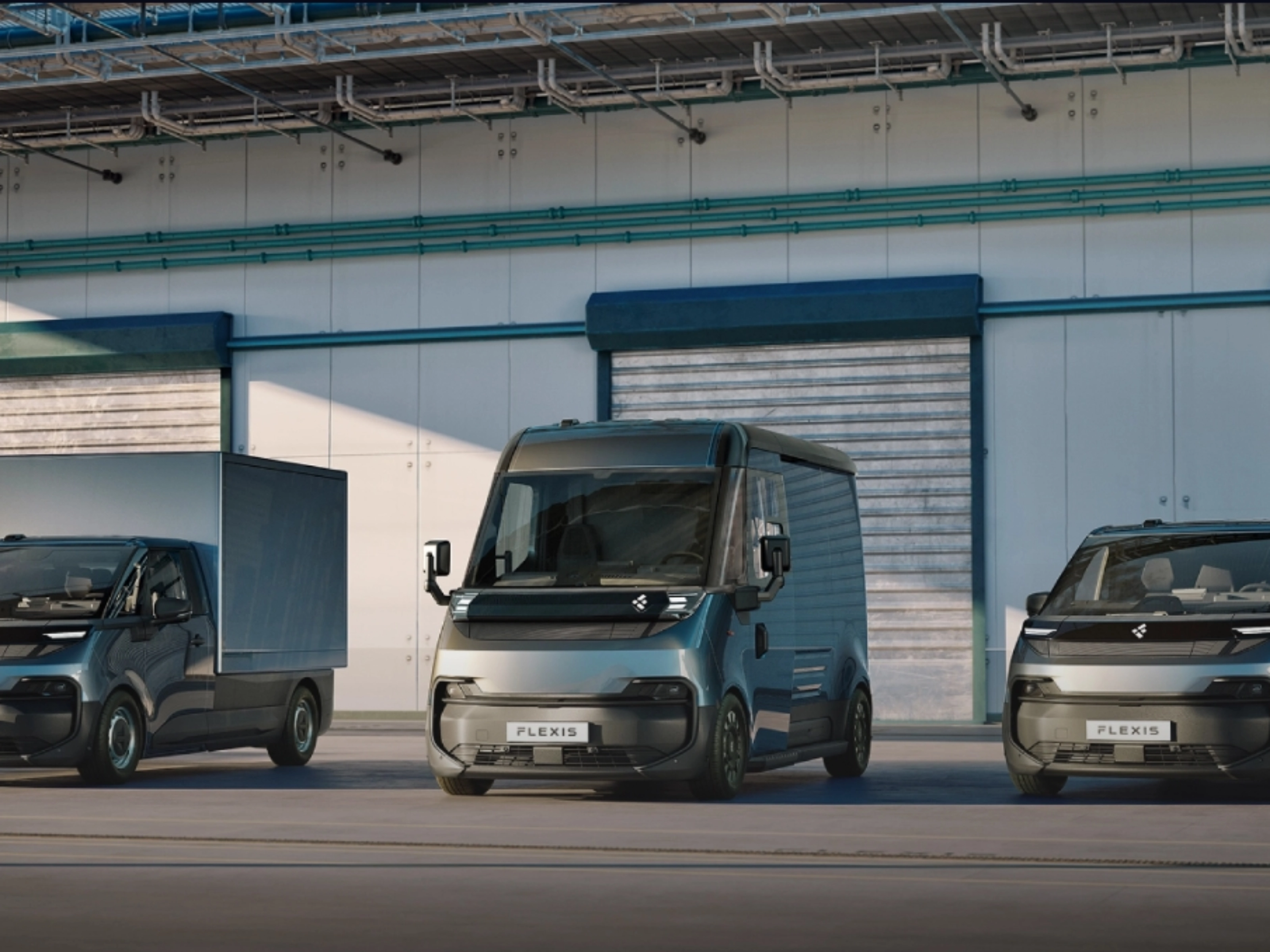 Three FLEXIS electric delivery vans parked in front of a warehouse.
