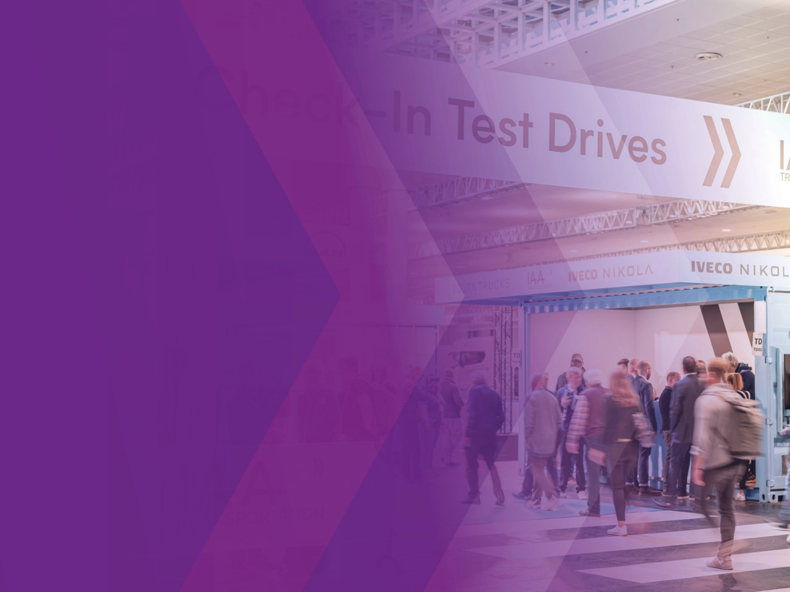 Visitors at IAA check-in area for test drives in exhibition hall.
