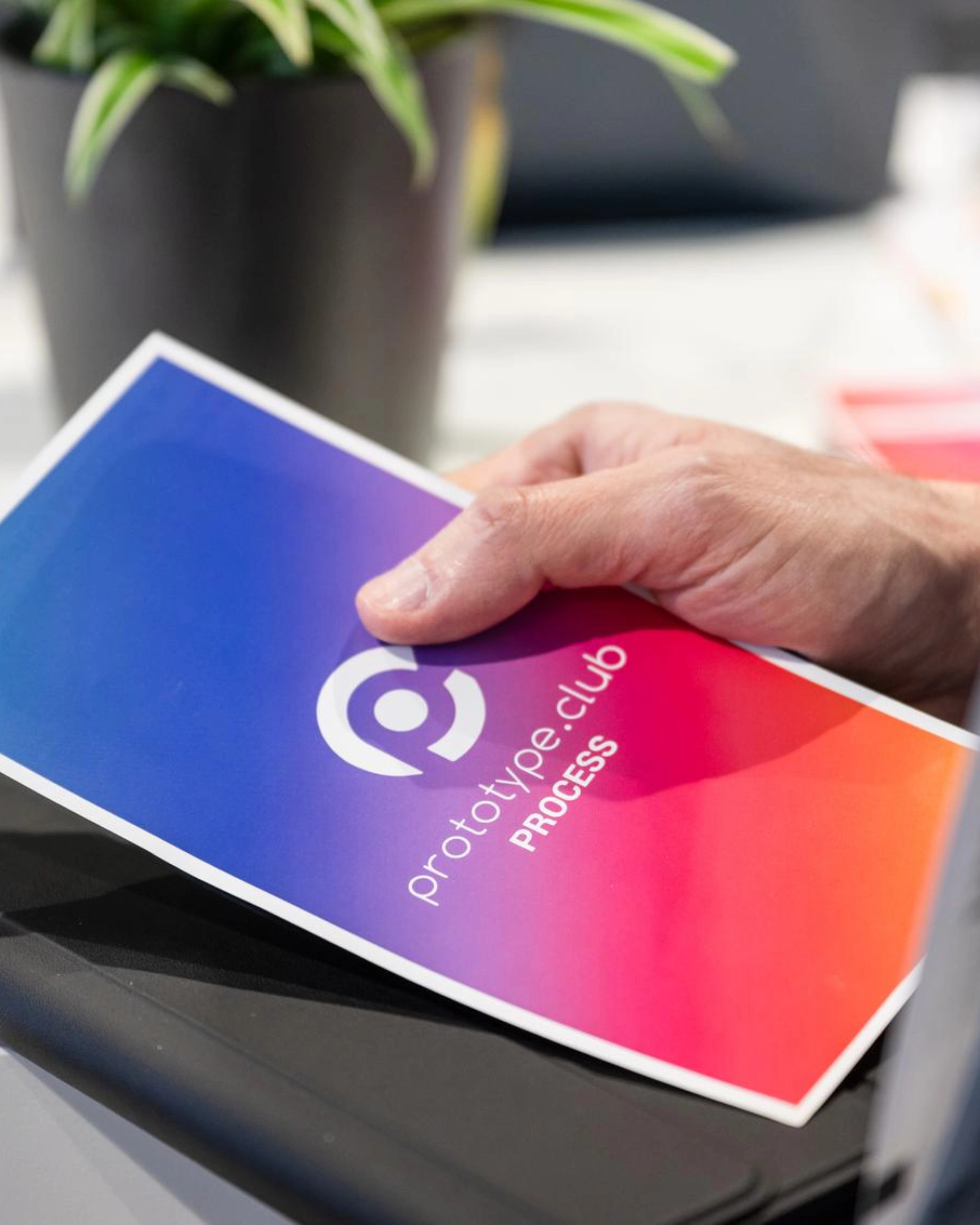 Person holding a prototype.club Process brochure at IAA Transportation.