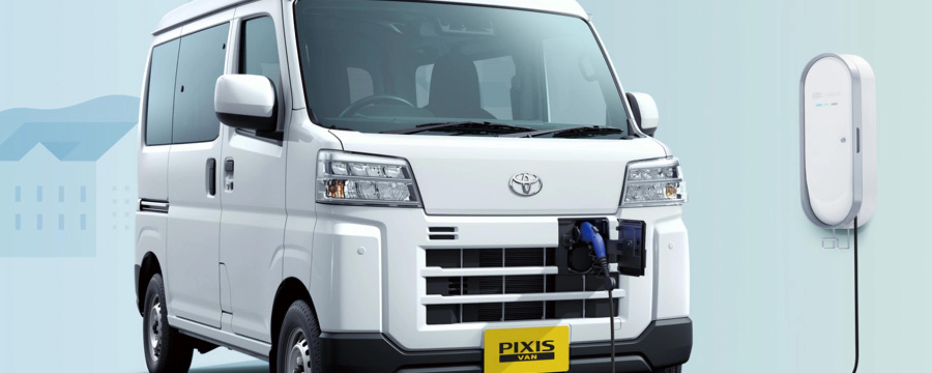 Electric van labeled "Pixis Van" is charging at a wall-mounted station via front charging port.
