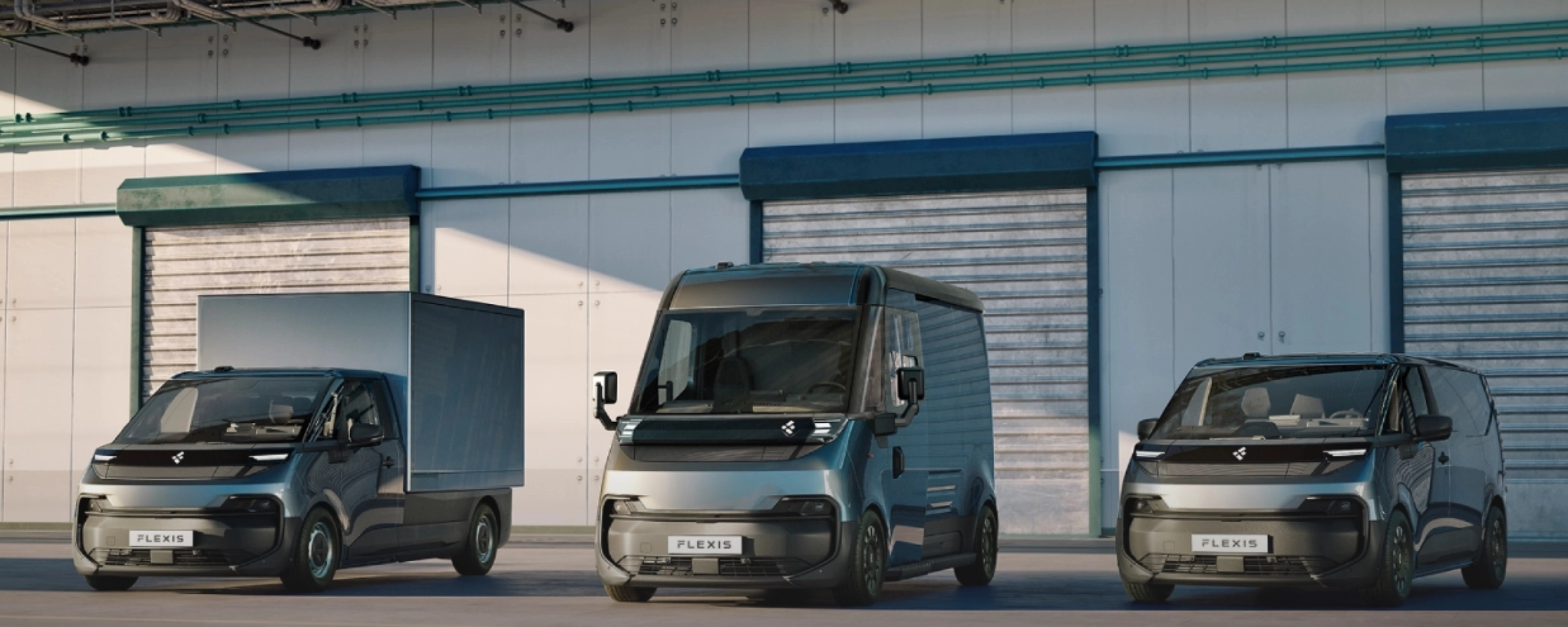 Three FLEXIS electric delivery vans parked in front of a warehouse.
