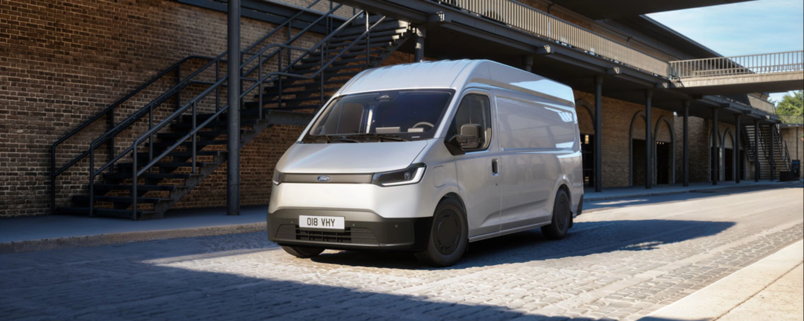 White van parked in a courtyard in front of a brick building
