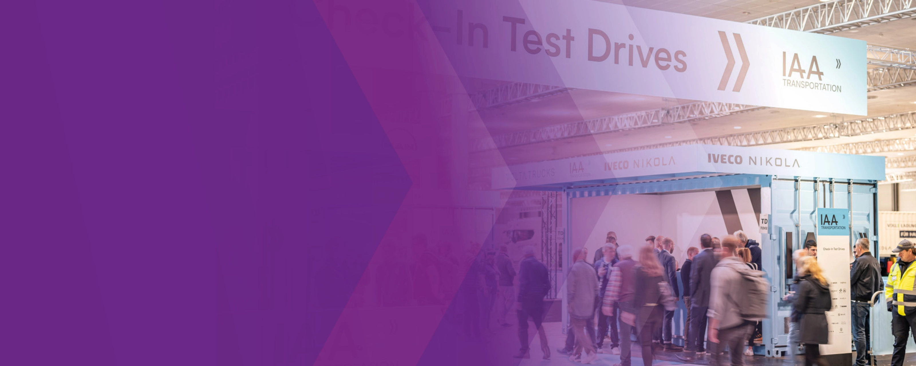 Visitors at IAA check-in area for test drives in exhibition hall.