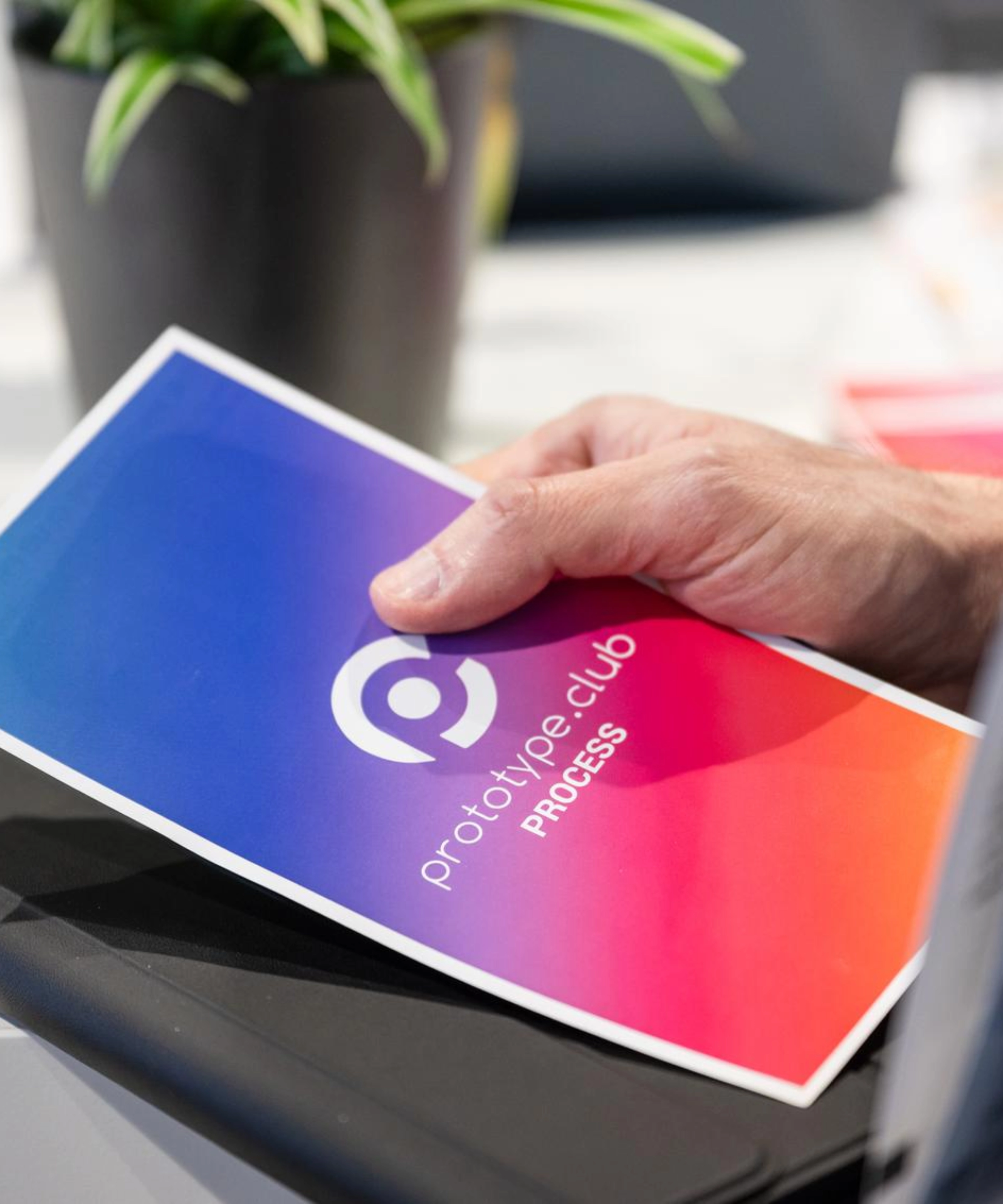 Person holding a prototype.club Process brochure at IAA Transportation.