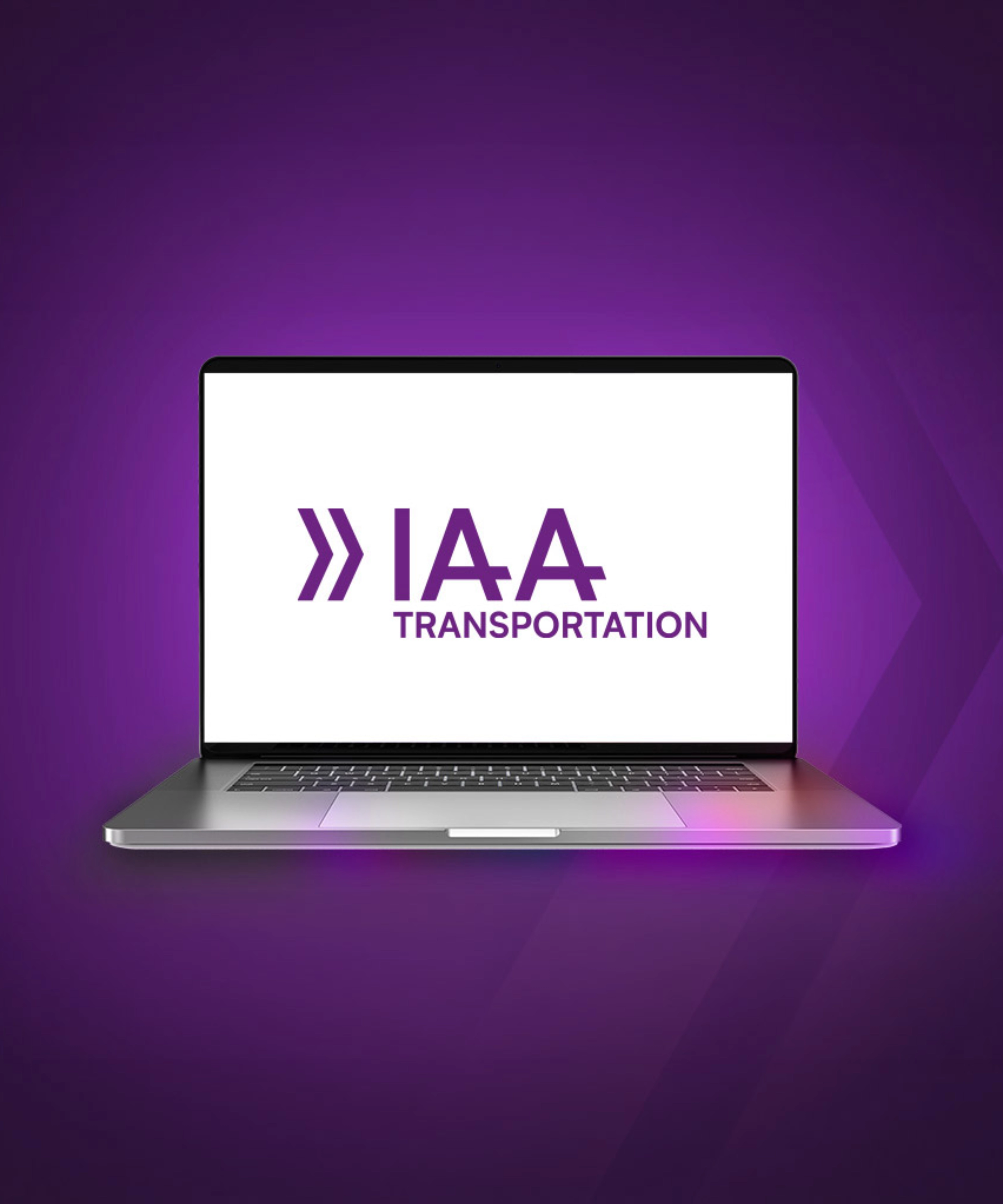 Laptop screen showing the IAA Transportation logo on a purple background.