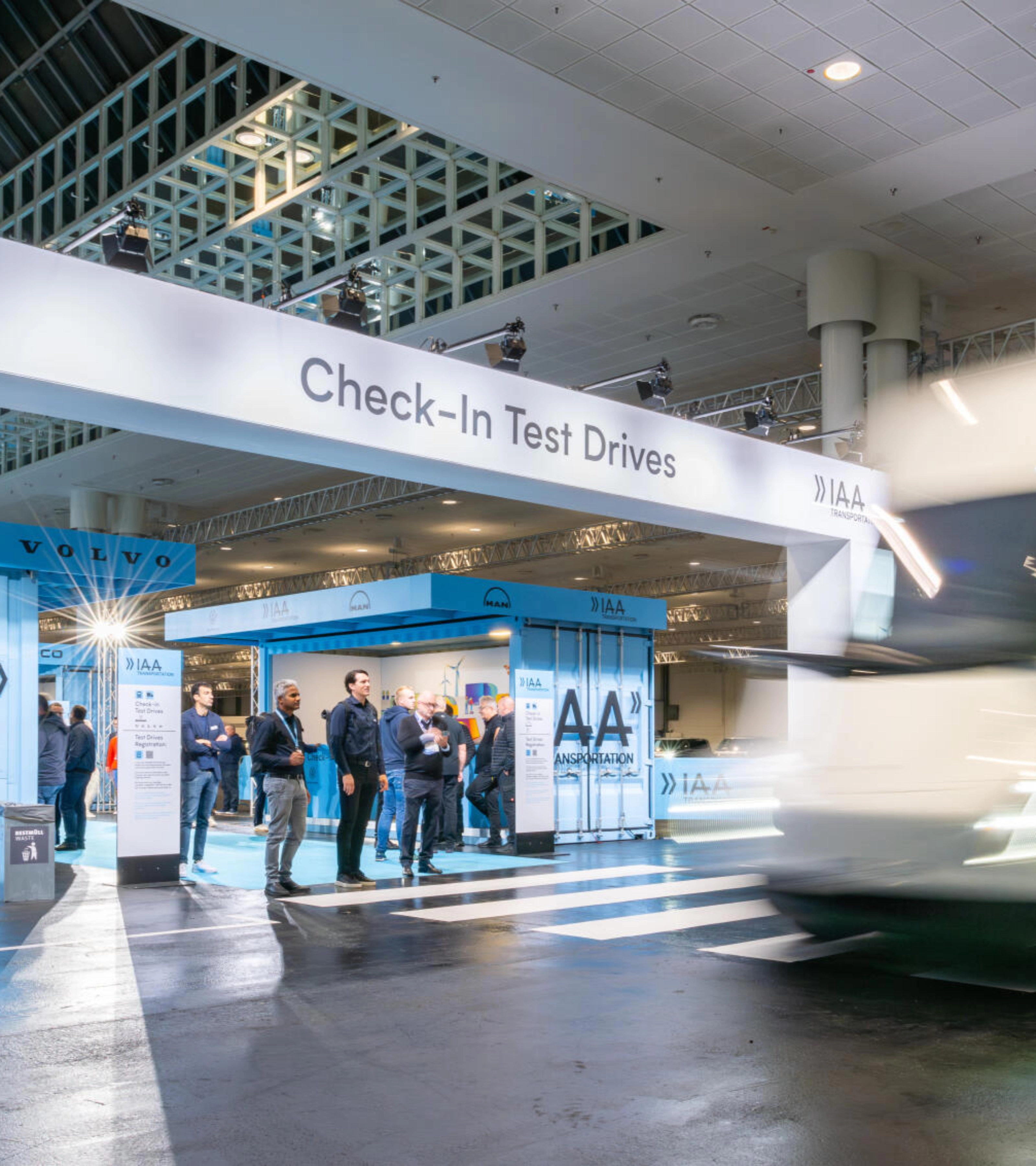 IAA Transportation Check-In area for test drives with truck passing by.