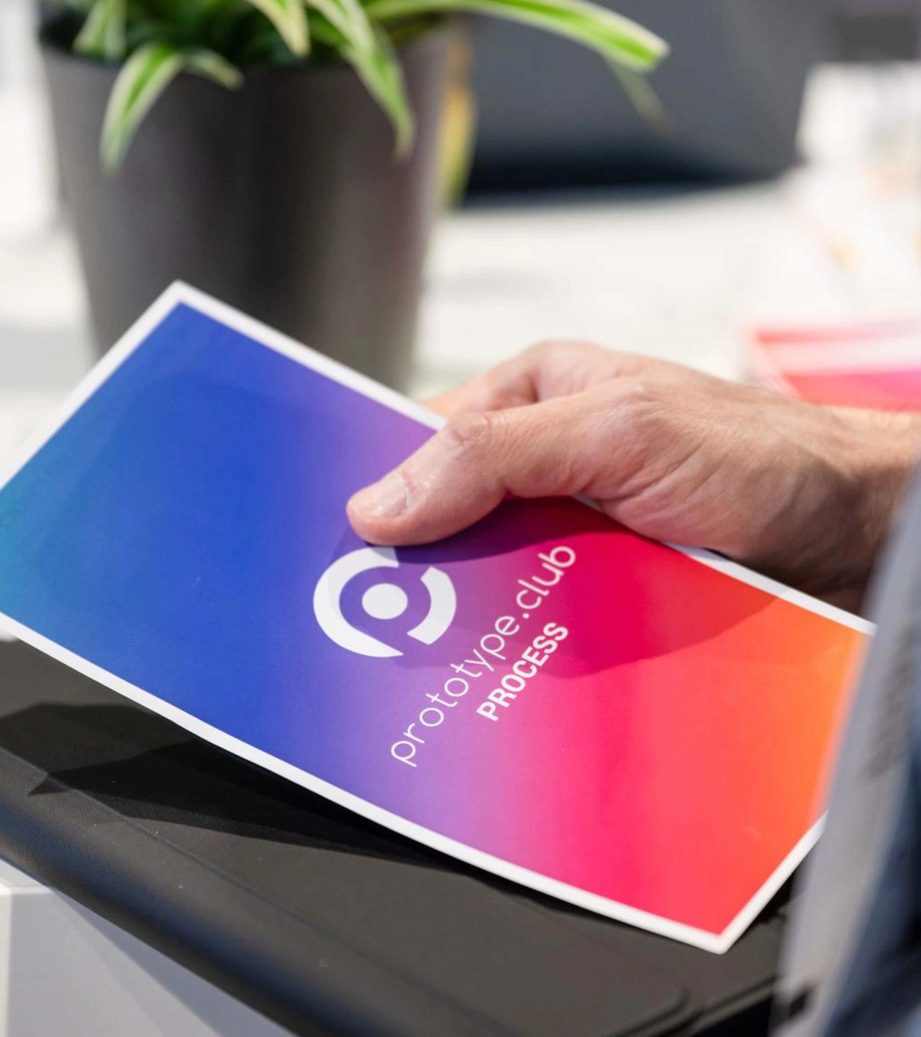 Person holding a prototype.club Process brochure at IAA Transportation.