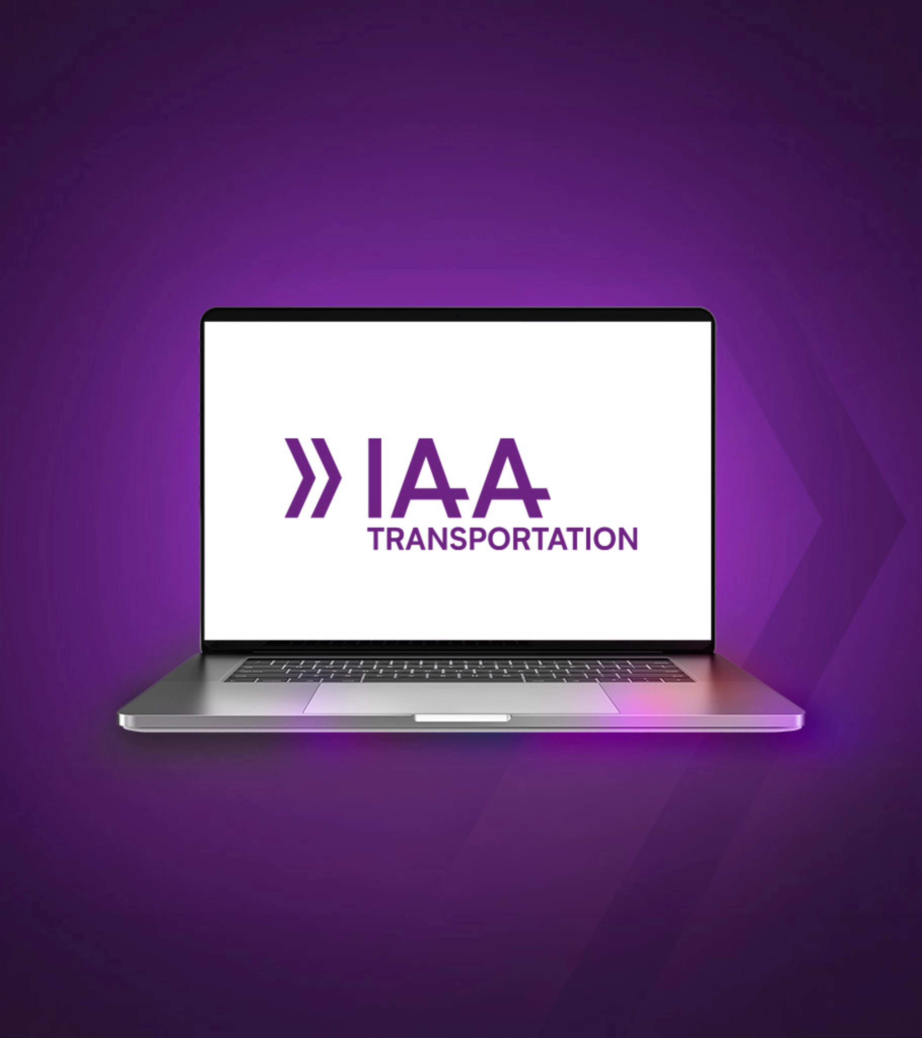 Laptop screen showing the IAA Transportation logo on a purple background.