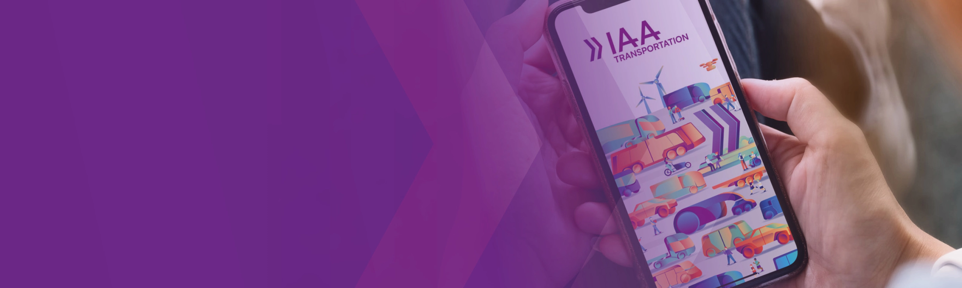 A person holds a smartphone showing a colorful app screen with the text IAA.