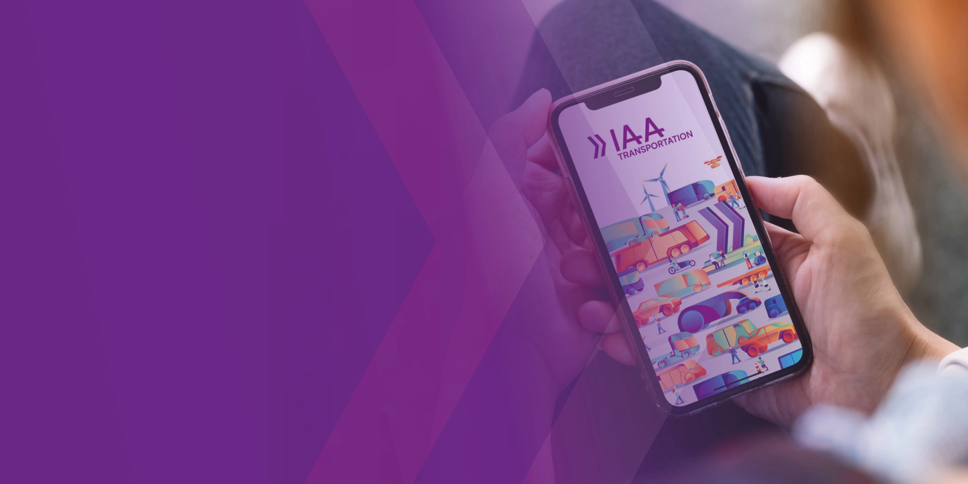 A person holds a smartphone showing a colorful app screen with the text IAA.