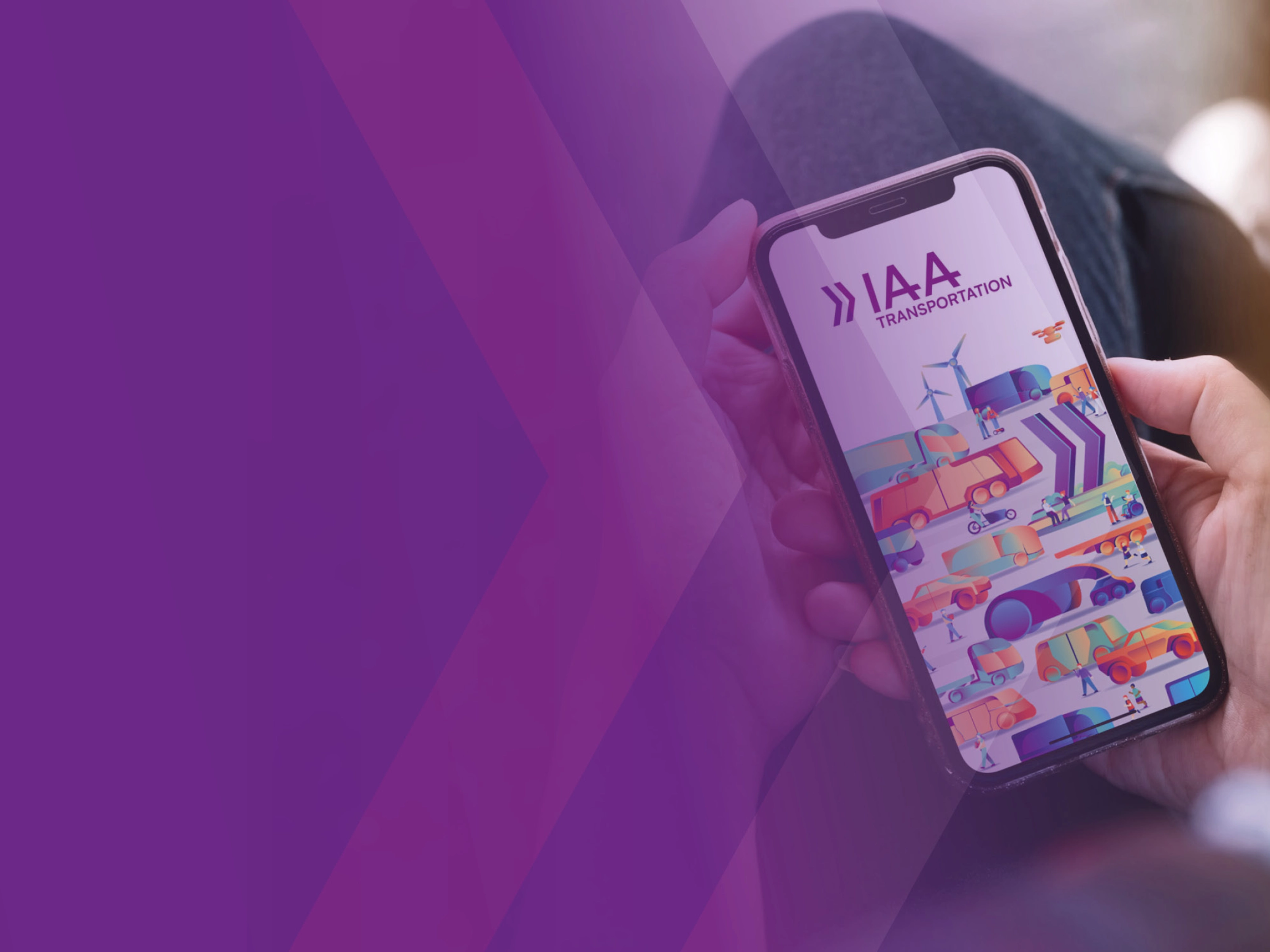 A person holds a smartphone showing a colorful app screen with the text IAA.