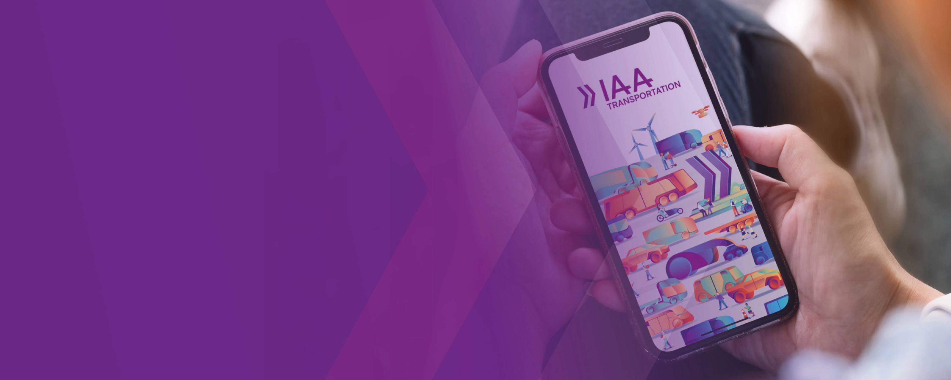 A person holds a smartphone showing a colorful app screen with the text IAA.
