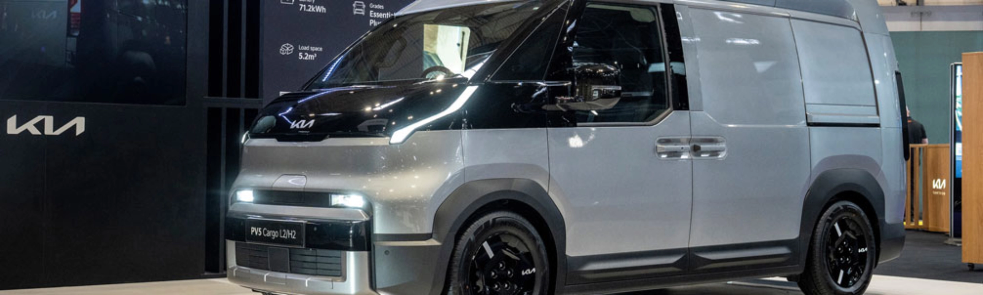 Kia PV5 Cargo van displayed at an indoor exhibition stand.