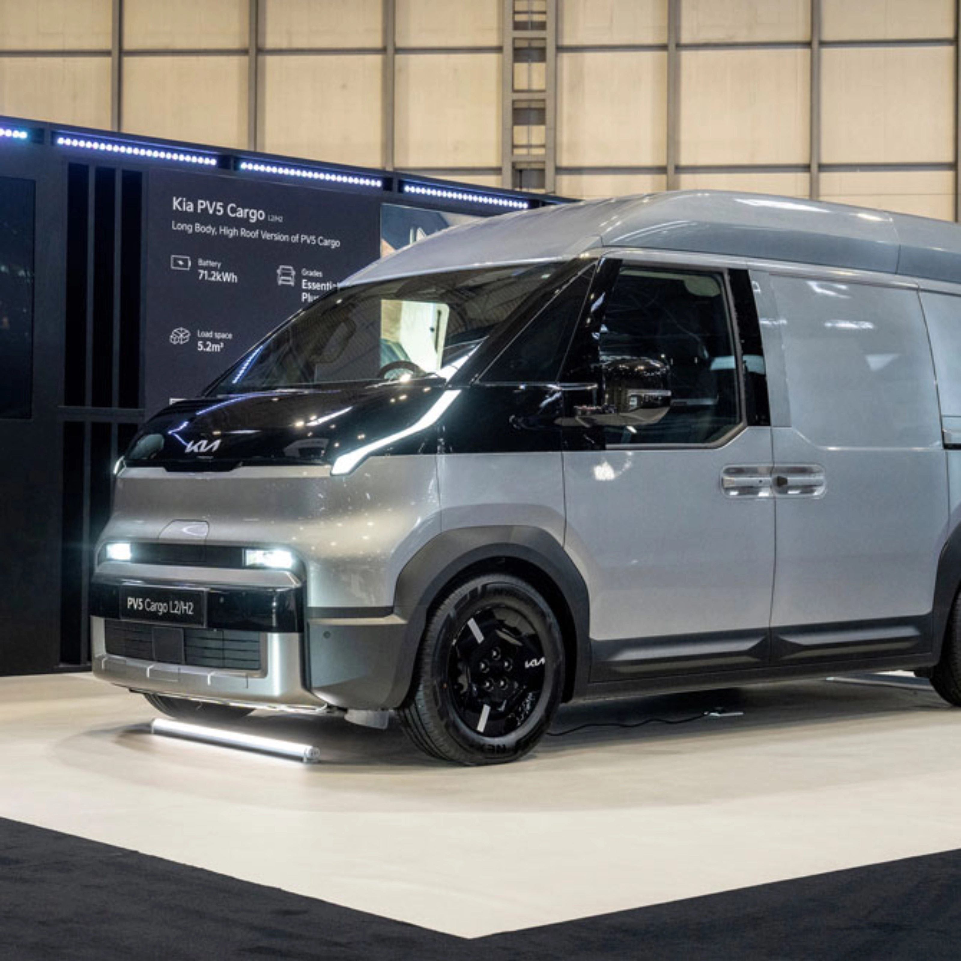 Kia PV5 Cargo van displayed at an indoor exhibition stand.