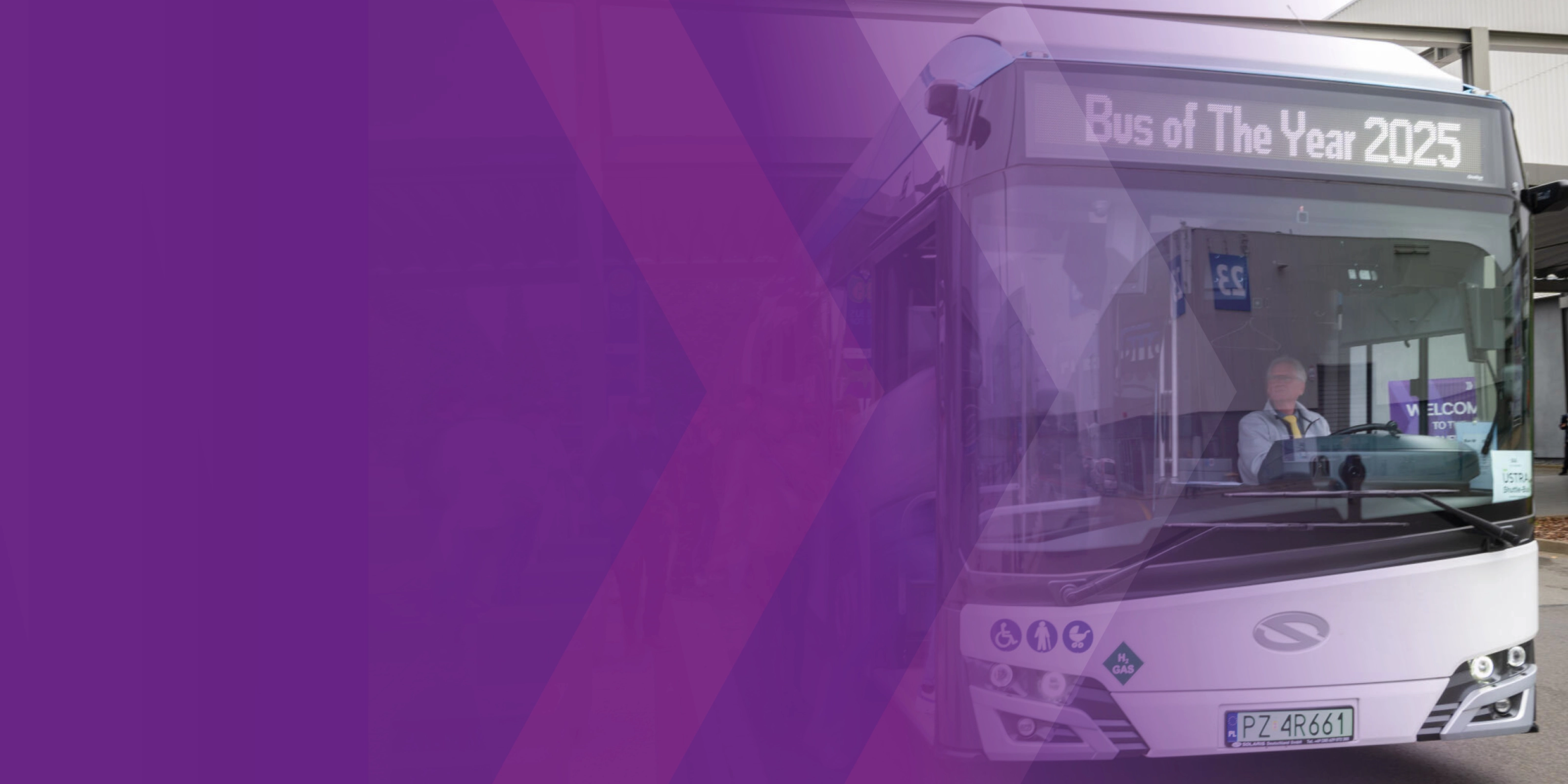 Bus with driver and display reading “Bus of The Year 2025”.