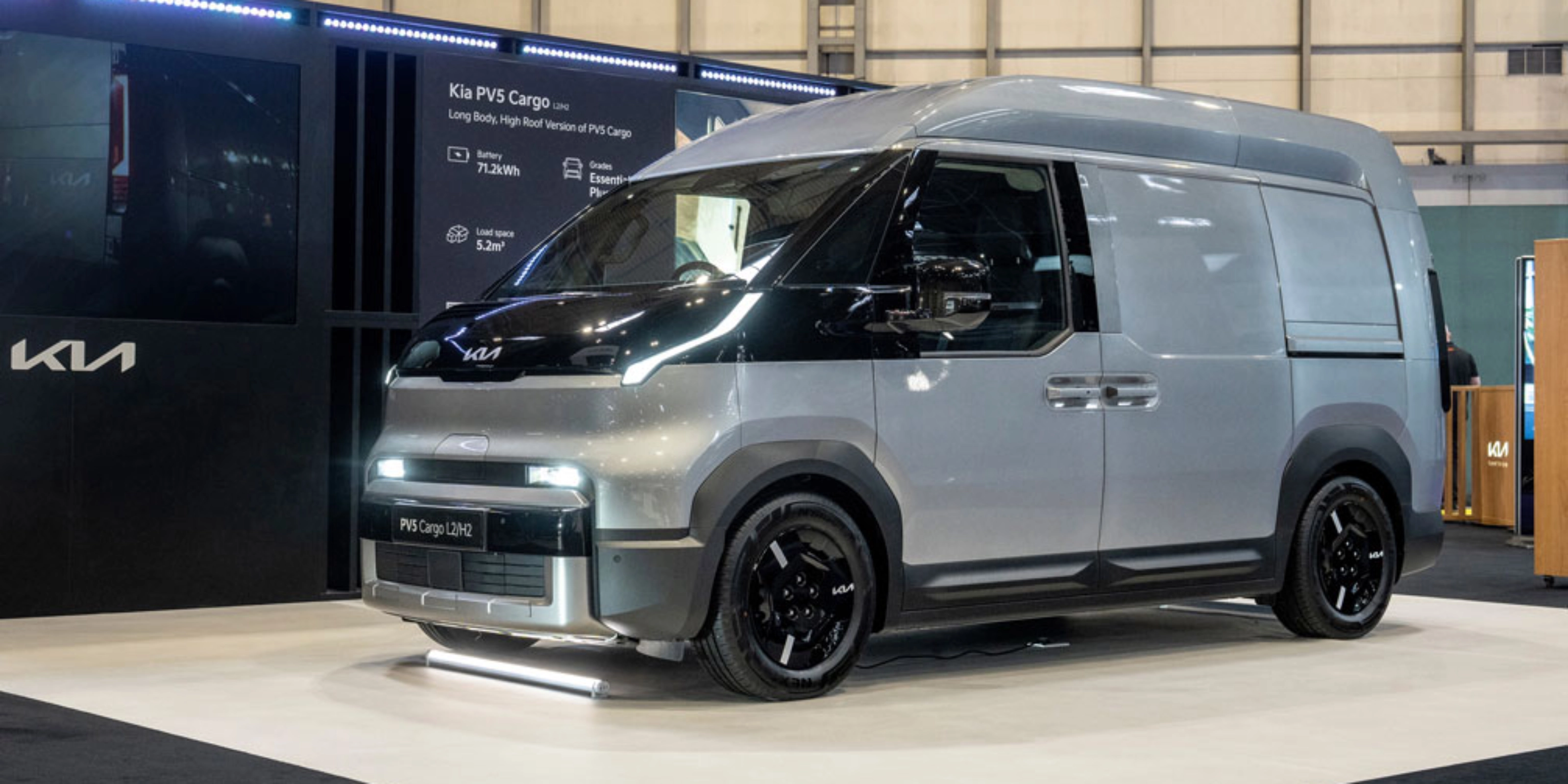 Kia PV5 Cargo van displayed at an indoor exhibition stand.