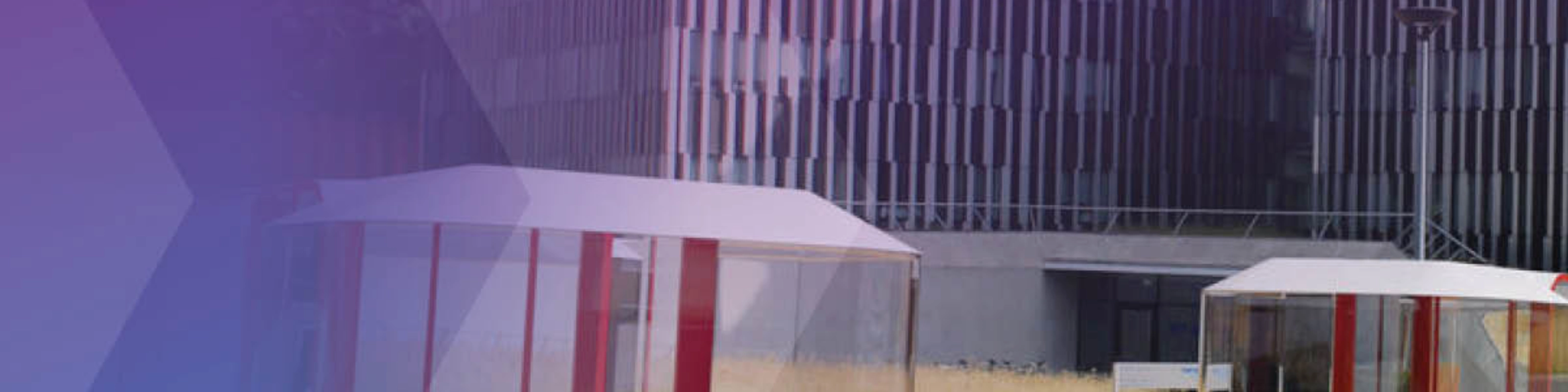 Several futuristic cable cars and ground pods are shown near a modern office building.