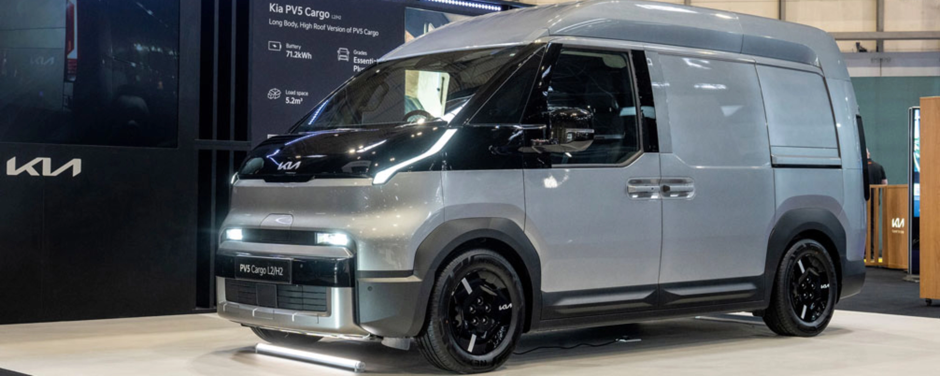 Kia PV5 Cargo van displayed at an indoor exhibition stand.