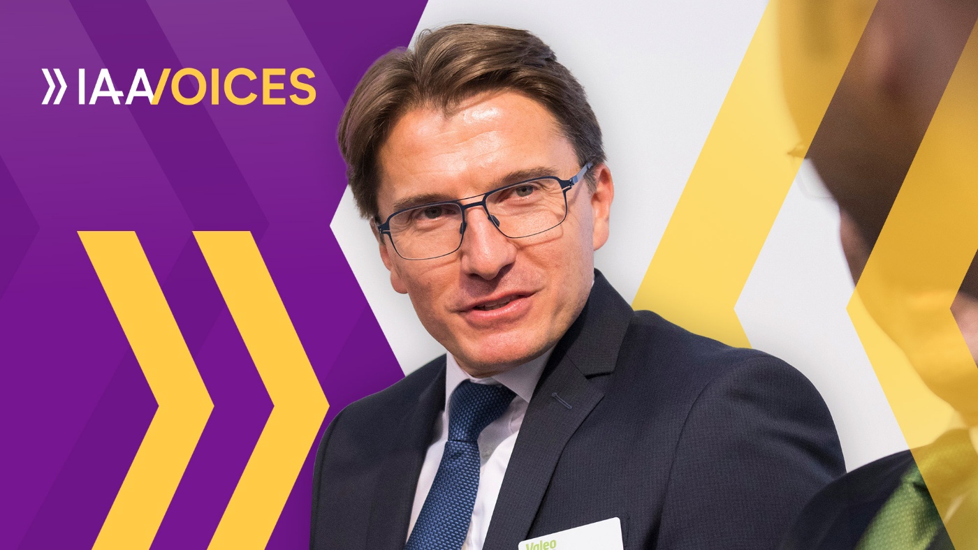 Portrait of Thierry Simonin in a suit and glasses, IAA Voices background.