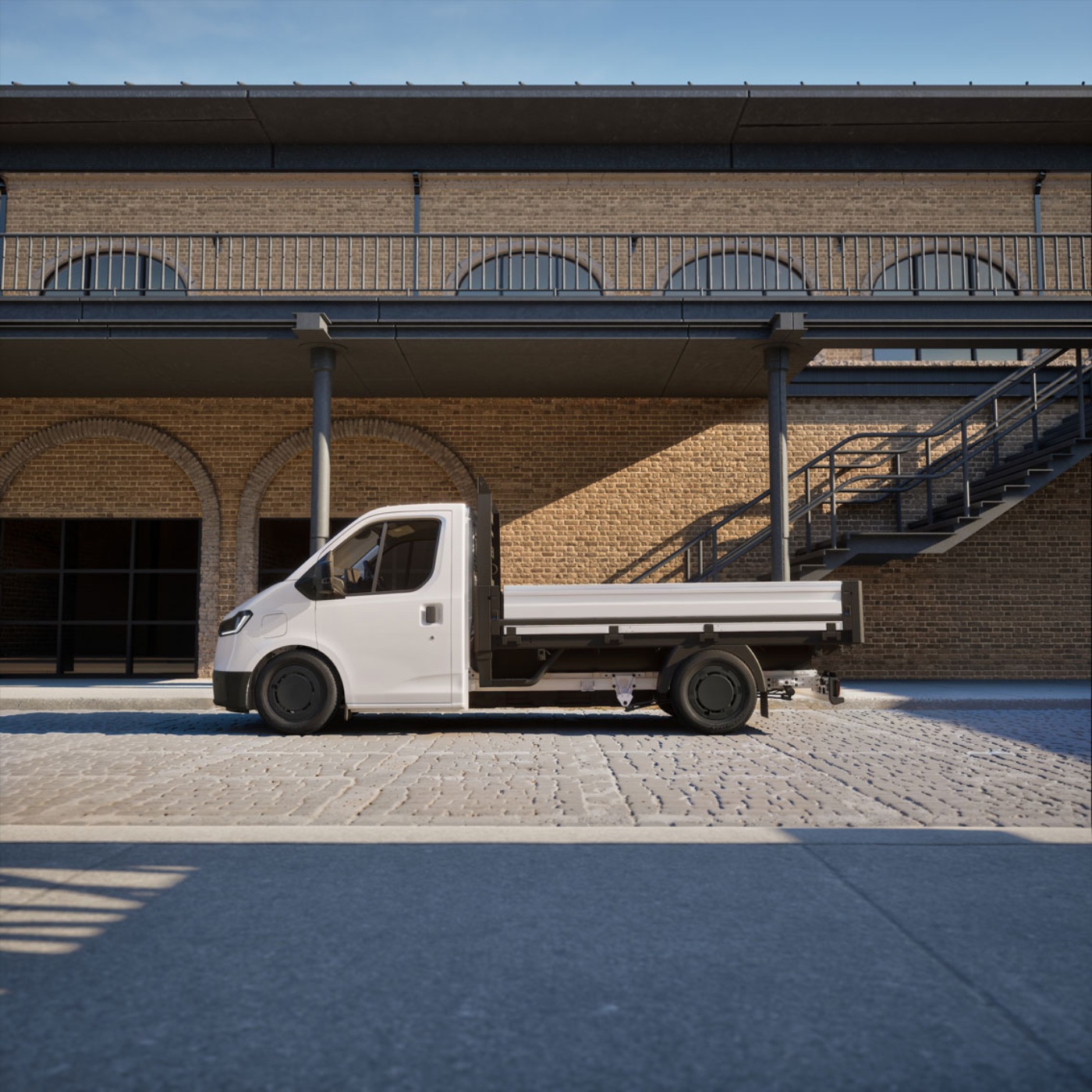 White flatbed truck parked in front of a brick building