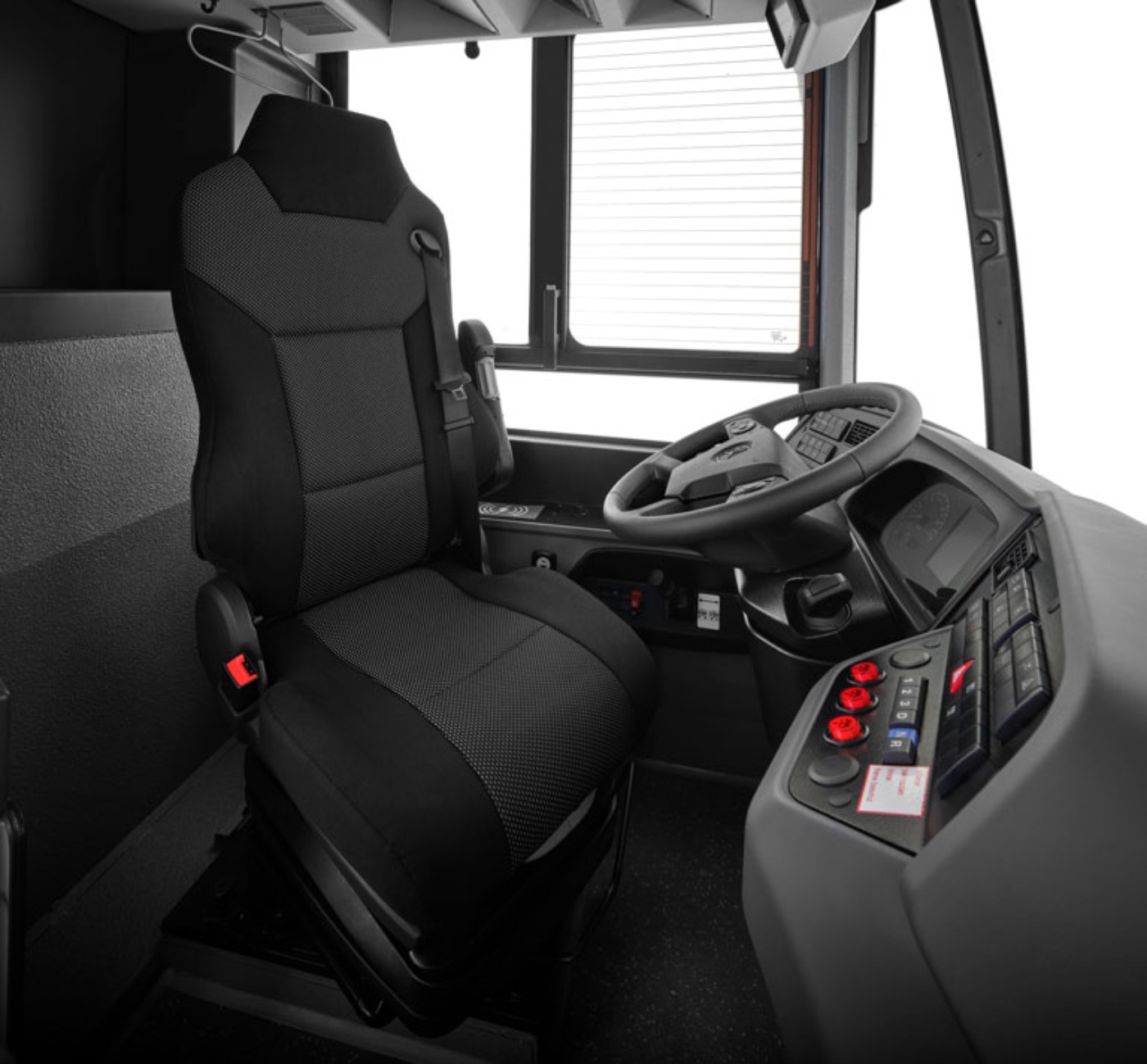 Driver’s seat and cockpit of a modern bus with steering wheel and control panel.