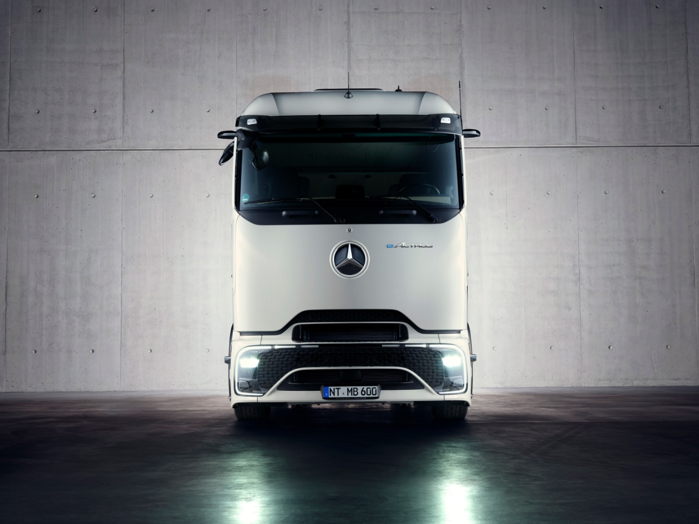 Front view of autonomous truck in industrial hall.