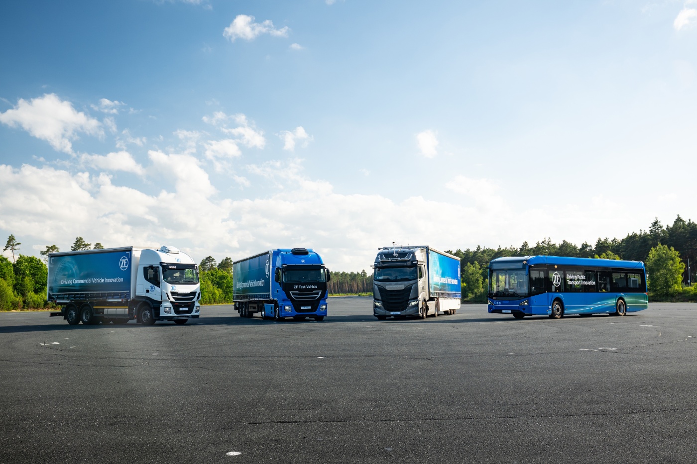 ZF test trucks and a bus parked on a test facility for transport innovation.