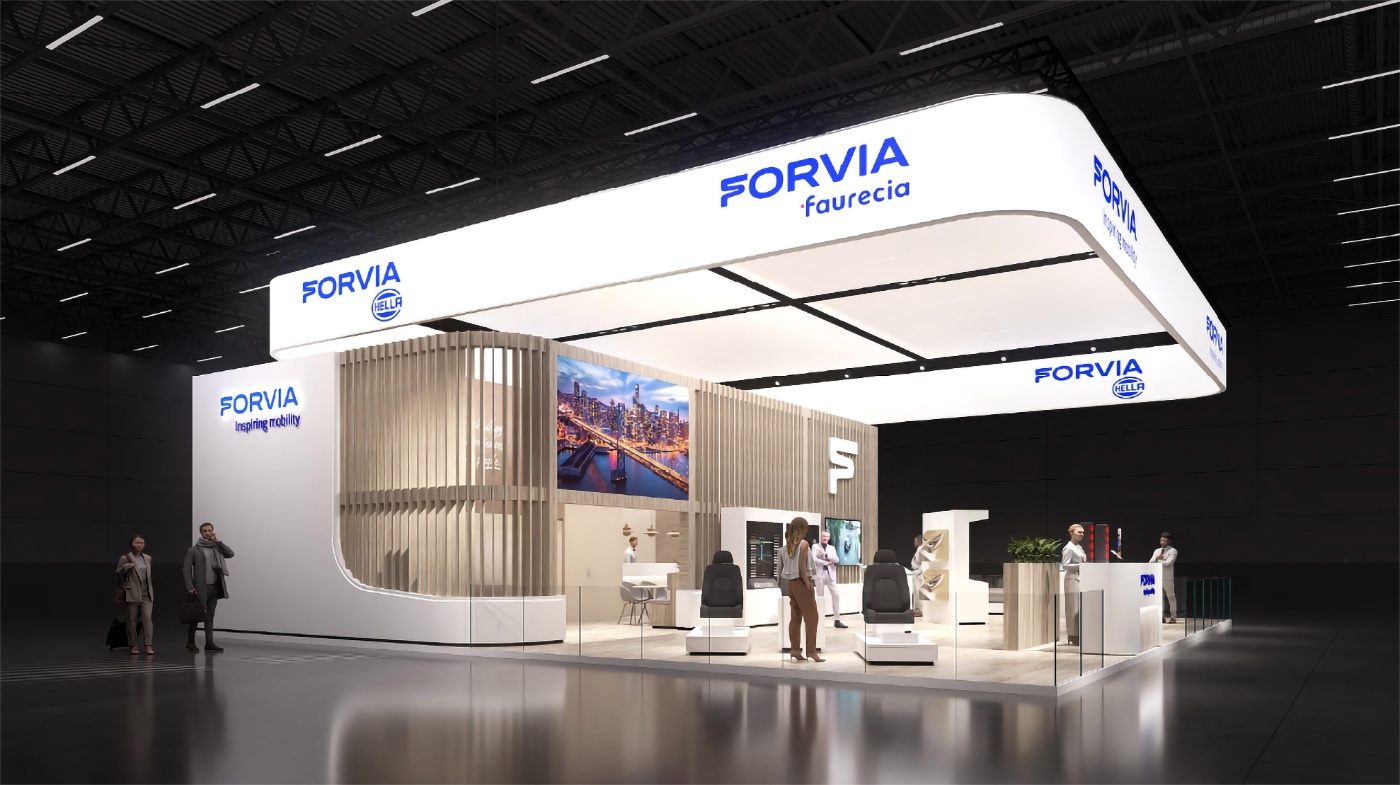 FORVIA exhibition booth with displays and meeting areas at a trade show.
